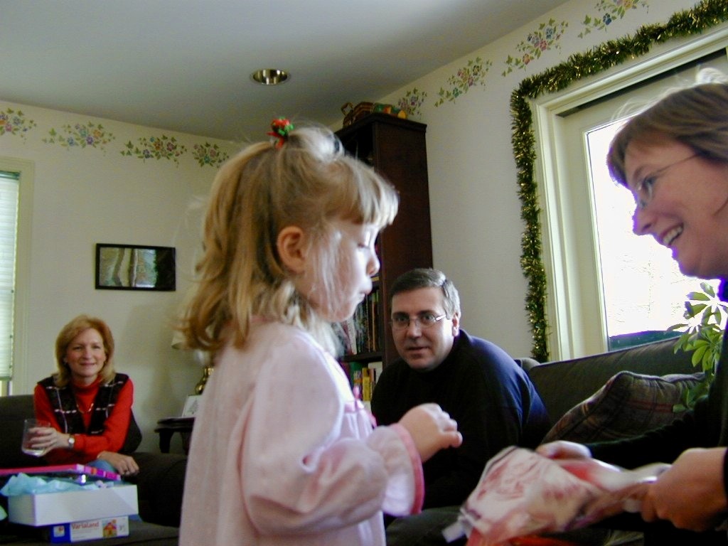 Alan smiling as a child opens a present at a family Christmas