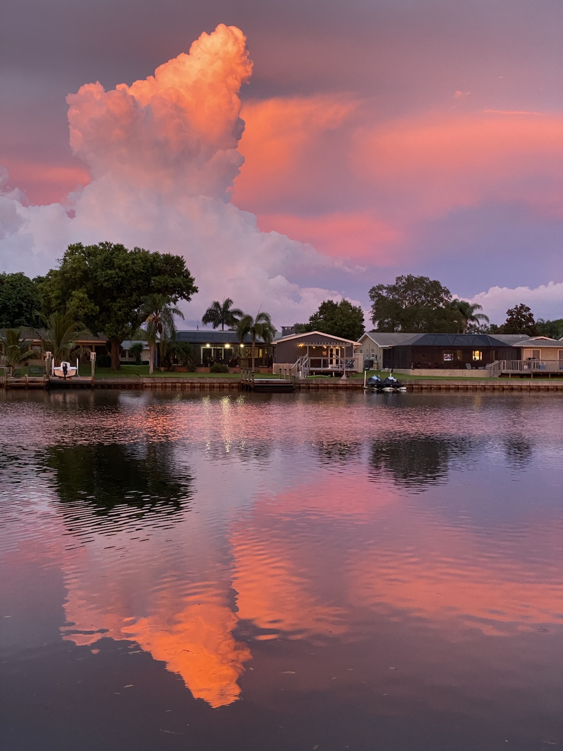 A pink summer cloud reflected almost perfectly in the calm creek.