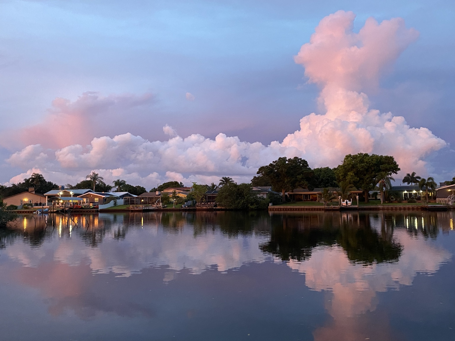Pastel storm clouds building over the homes across Allen's Creek.