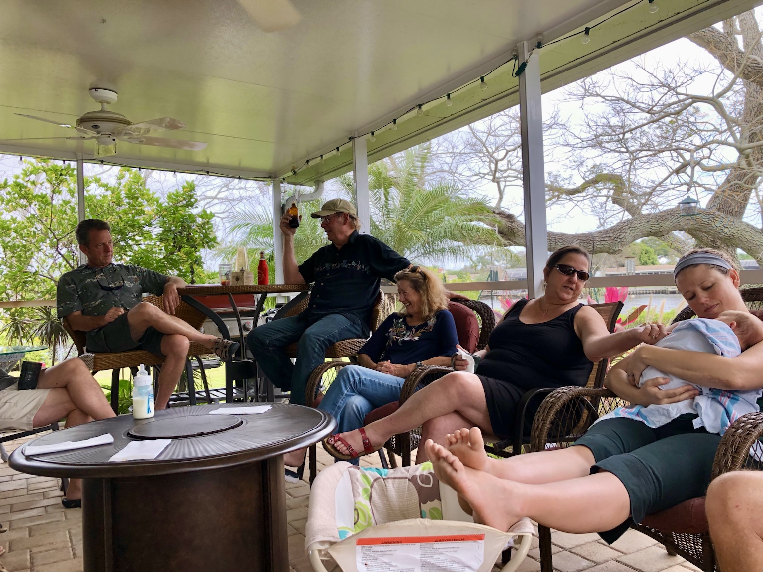 Friends and family gathered on the screened porch around a small fire.