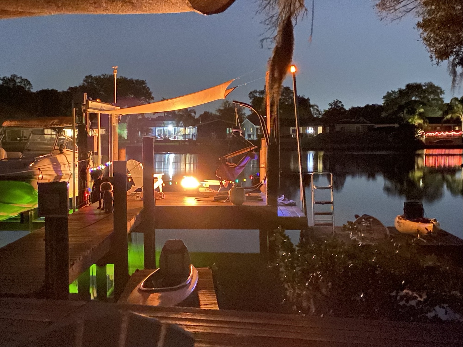An evening gathering on the dock with warm lights and water all around us.
