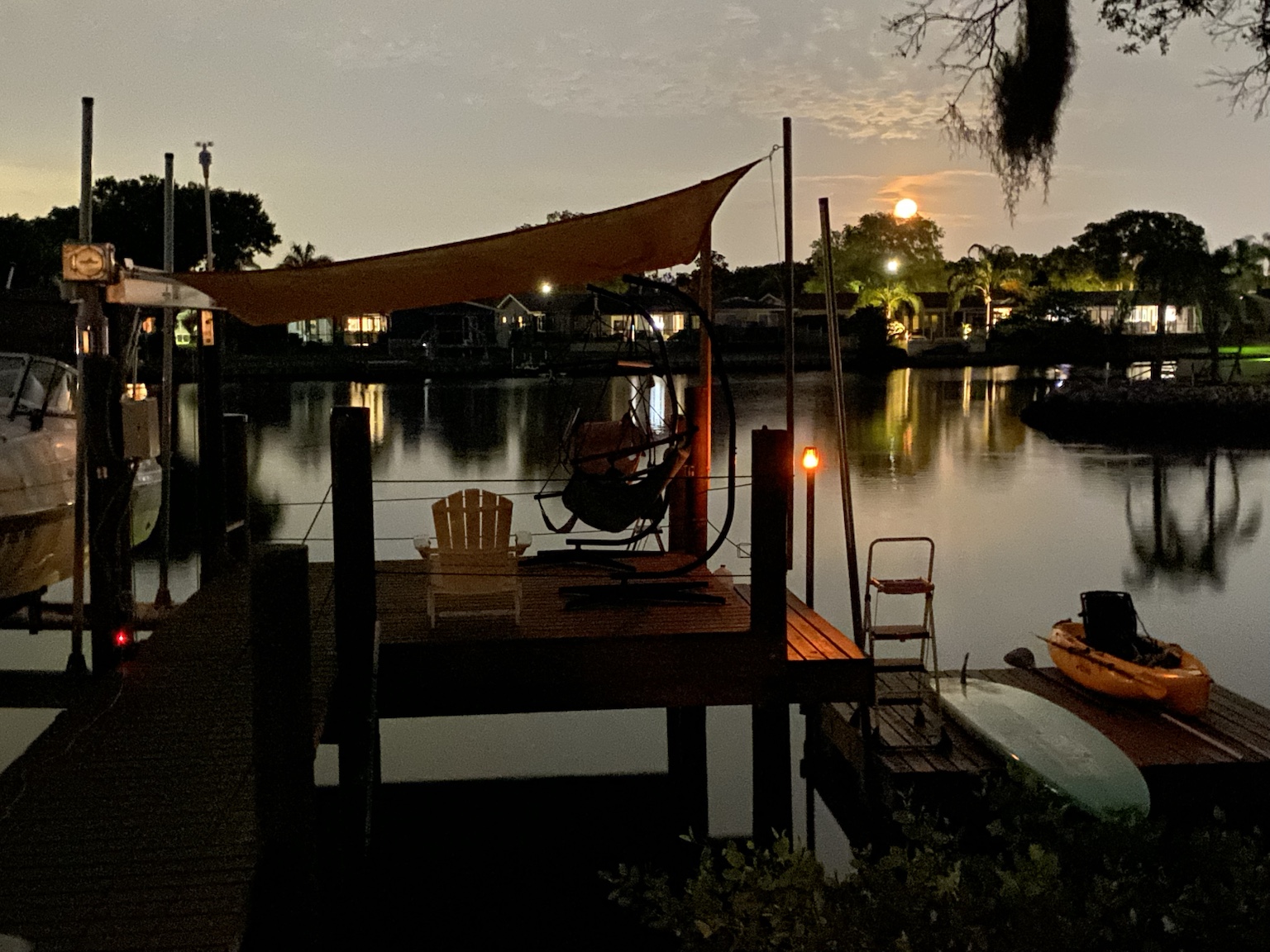 The waterfront glowing with dock lights after sunset.