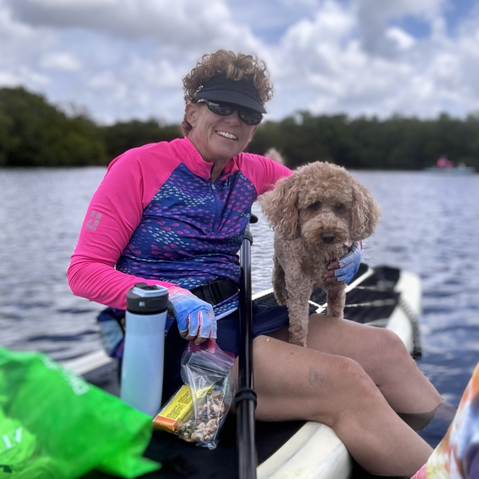 Kayak passenger, river guide, and part-time bow ornament, all in one small curly package.