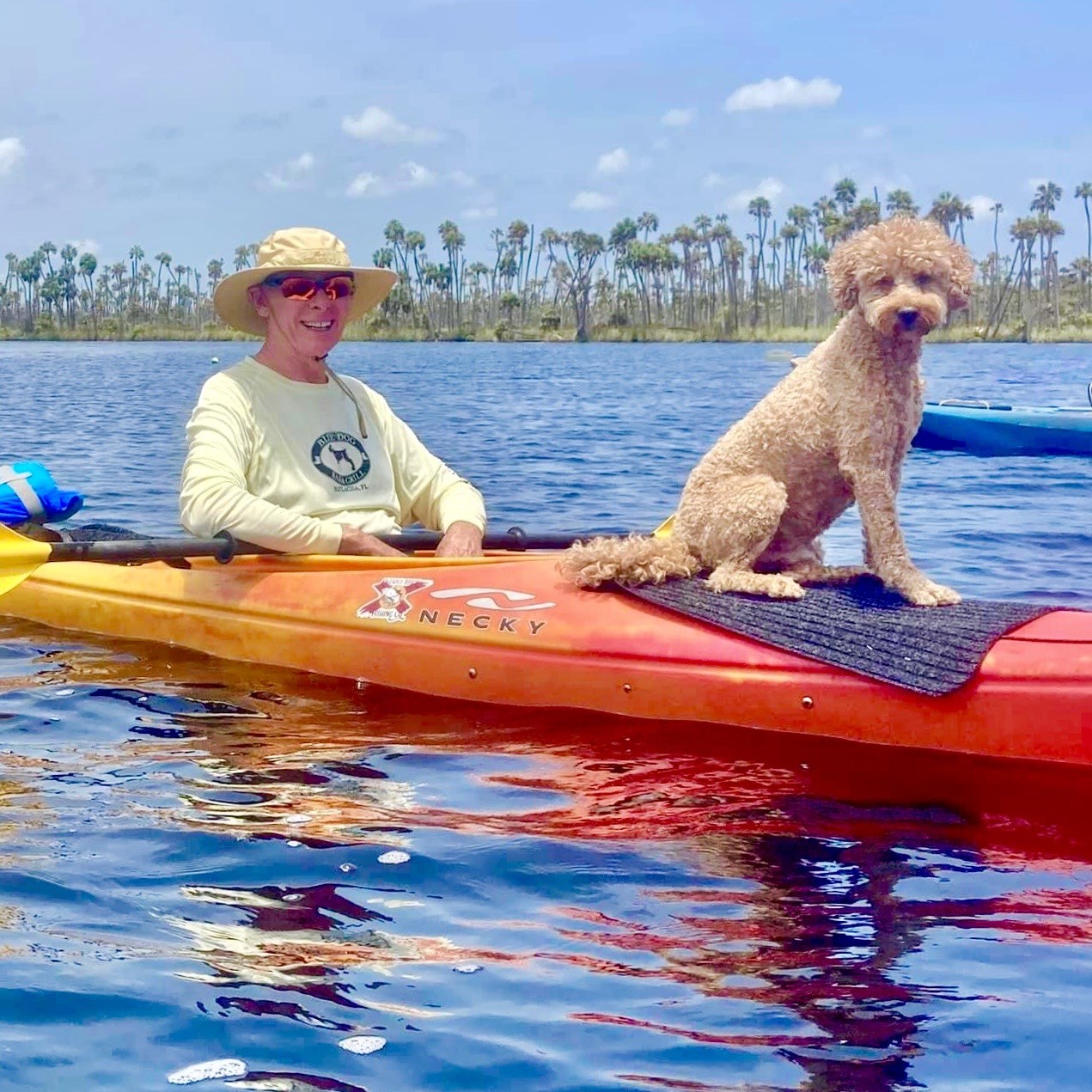 Kayaking with Buddyboy in bright blue water — the captain and co-captain making it look easy.