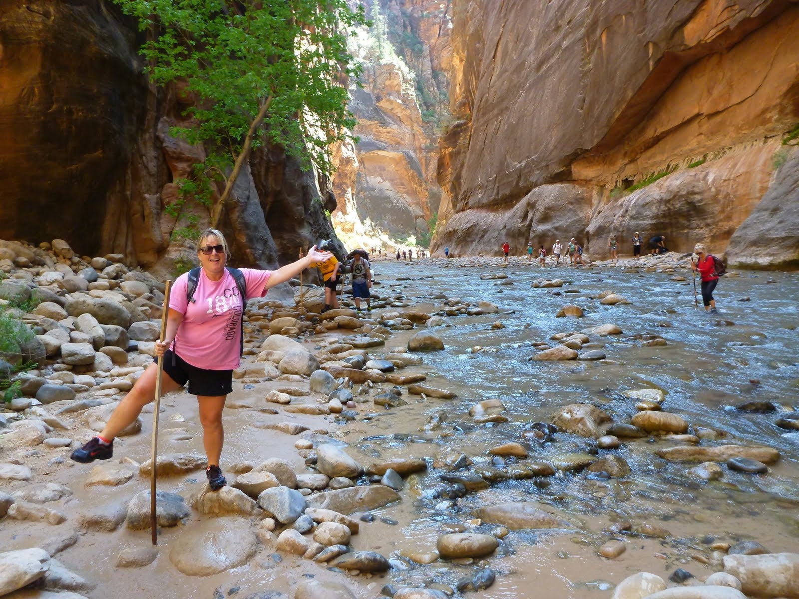 Cindy playfully balancing on the rounded stones of the Virgin River.