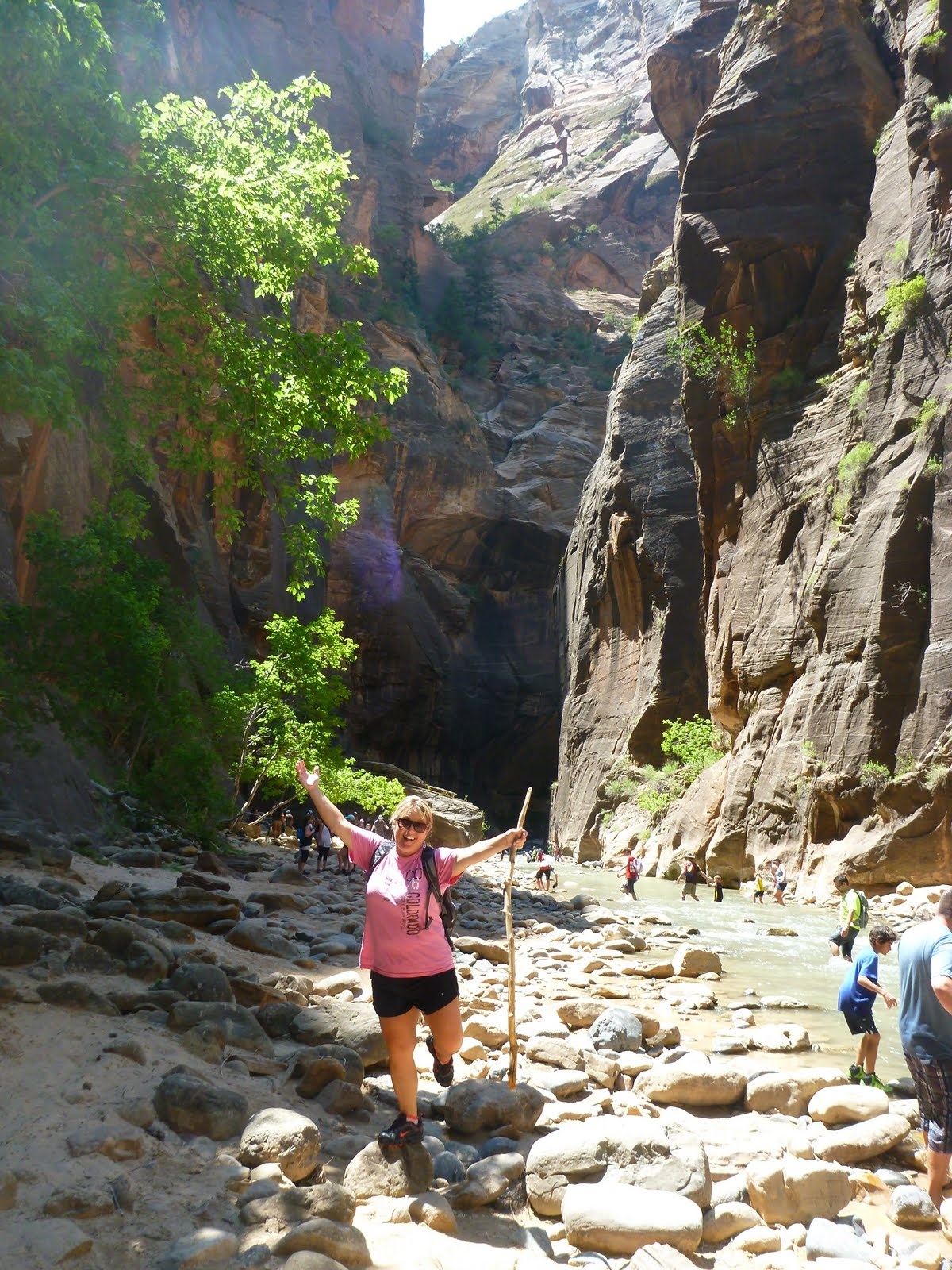 Cindy standing beneath the immense cliffs of the Narrows.