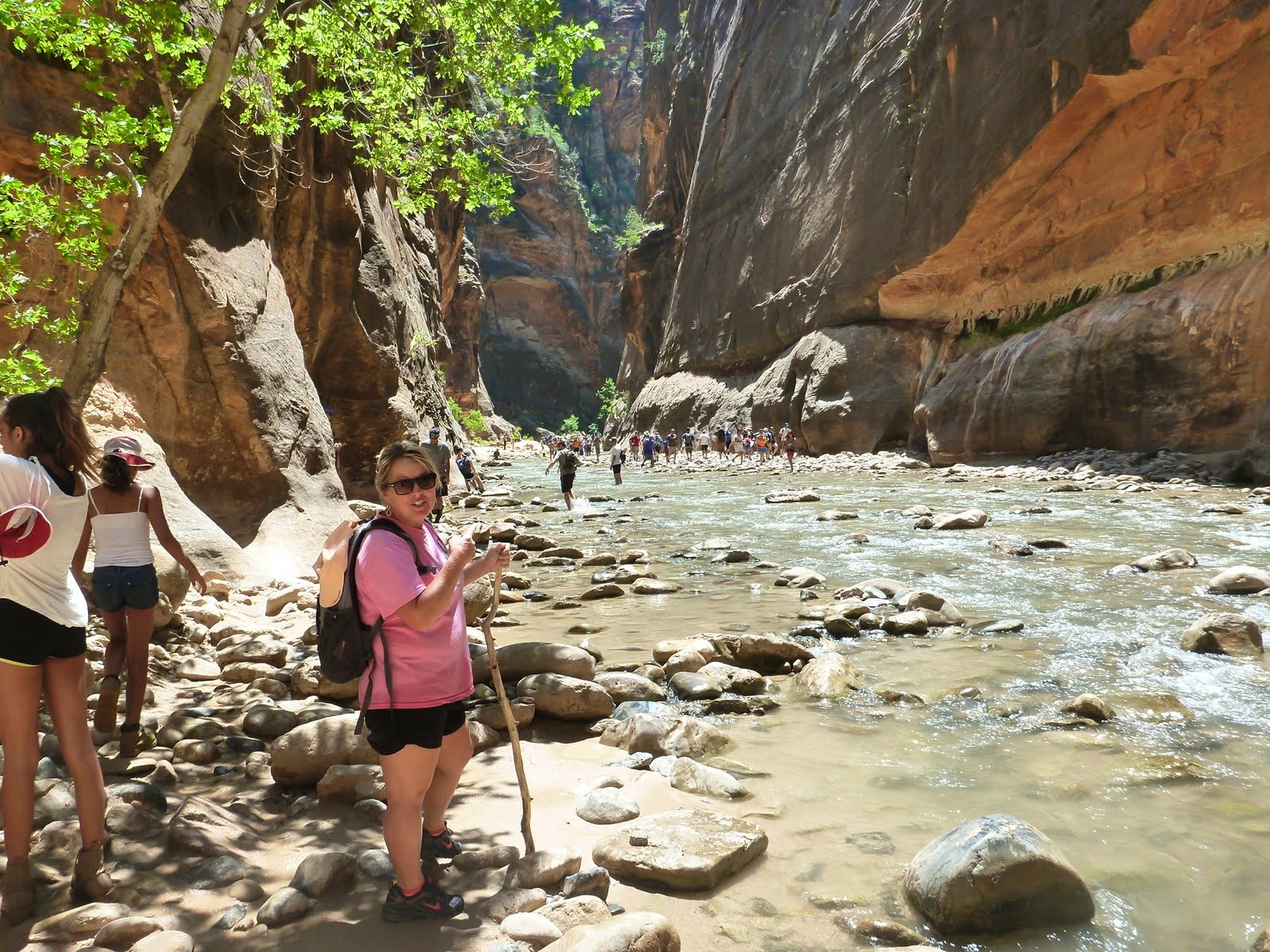 Cindy walking through a bright, open stretch of the Virgin River.