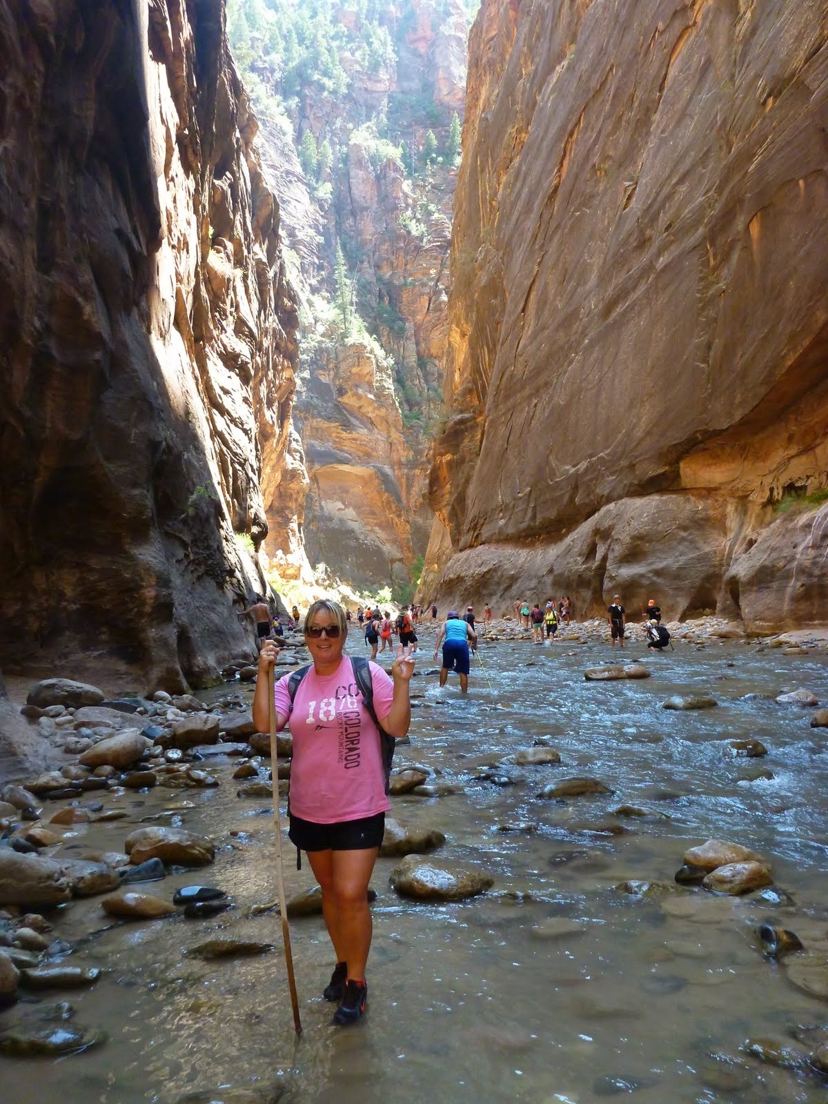 Cindy walking through a narrow, dramatic section of the river canyon.