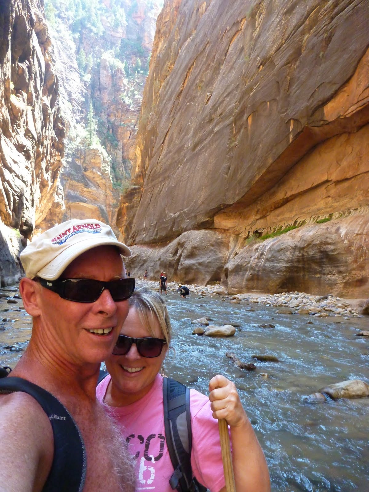 Tim and Cindy farther into the canyon with the river behind them.