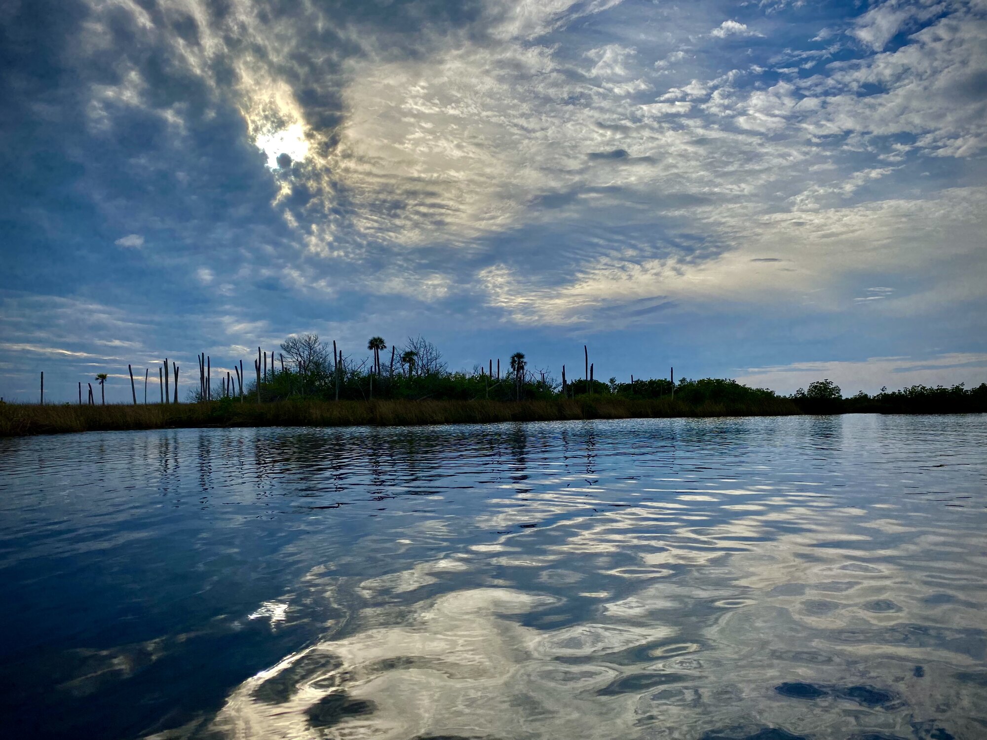 Storm-influenced evening sky reflected over Gulf water