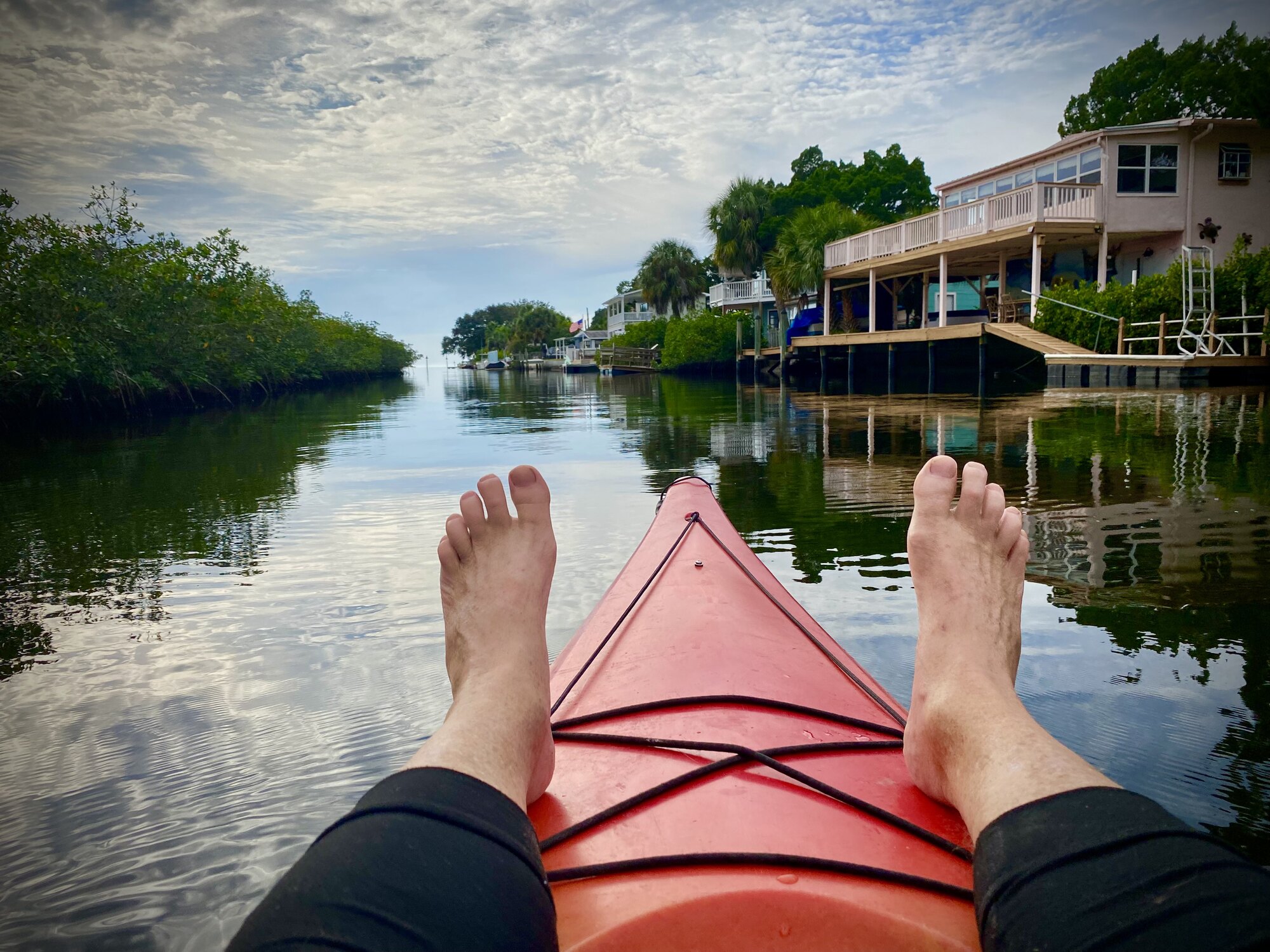 Relaxing with feet up in red kayak along Aripeka canal