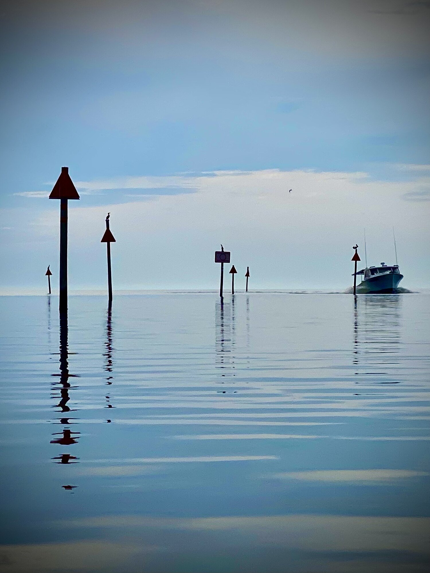 Red channel marker reflected in calm Gulf water