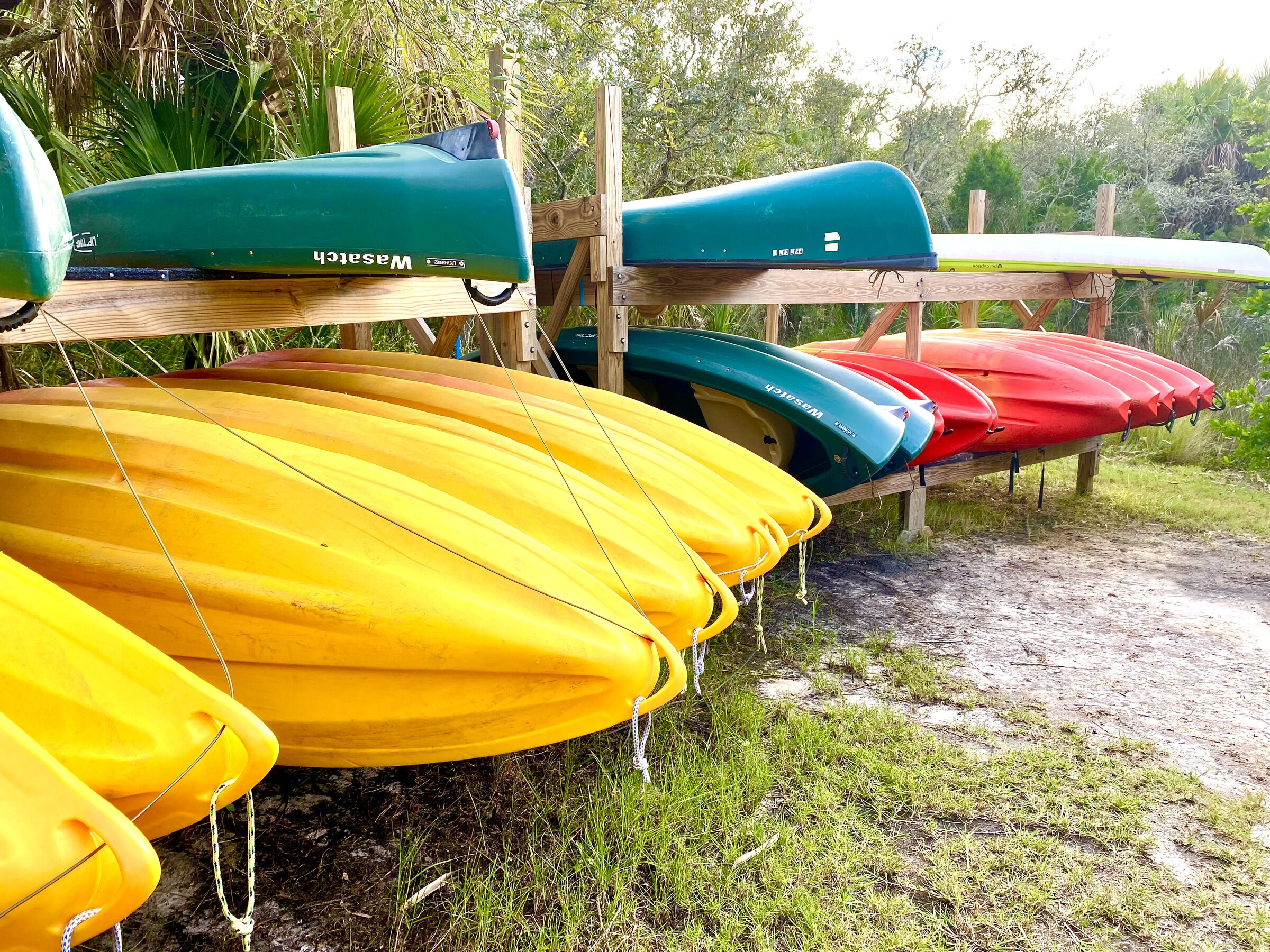 Colorful kayaks stored near the launch