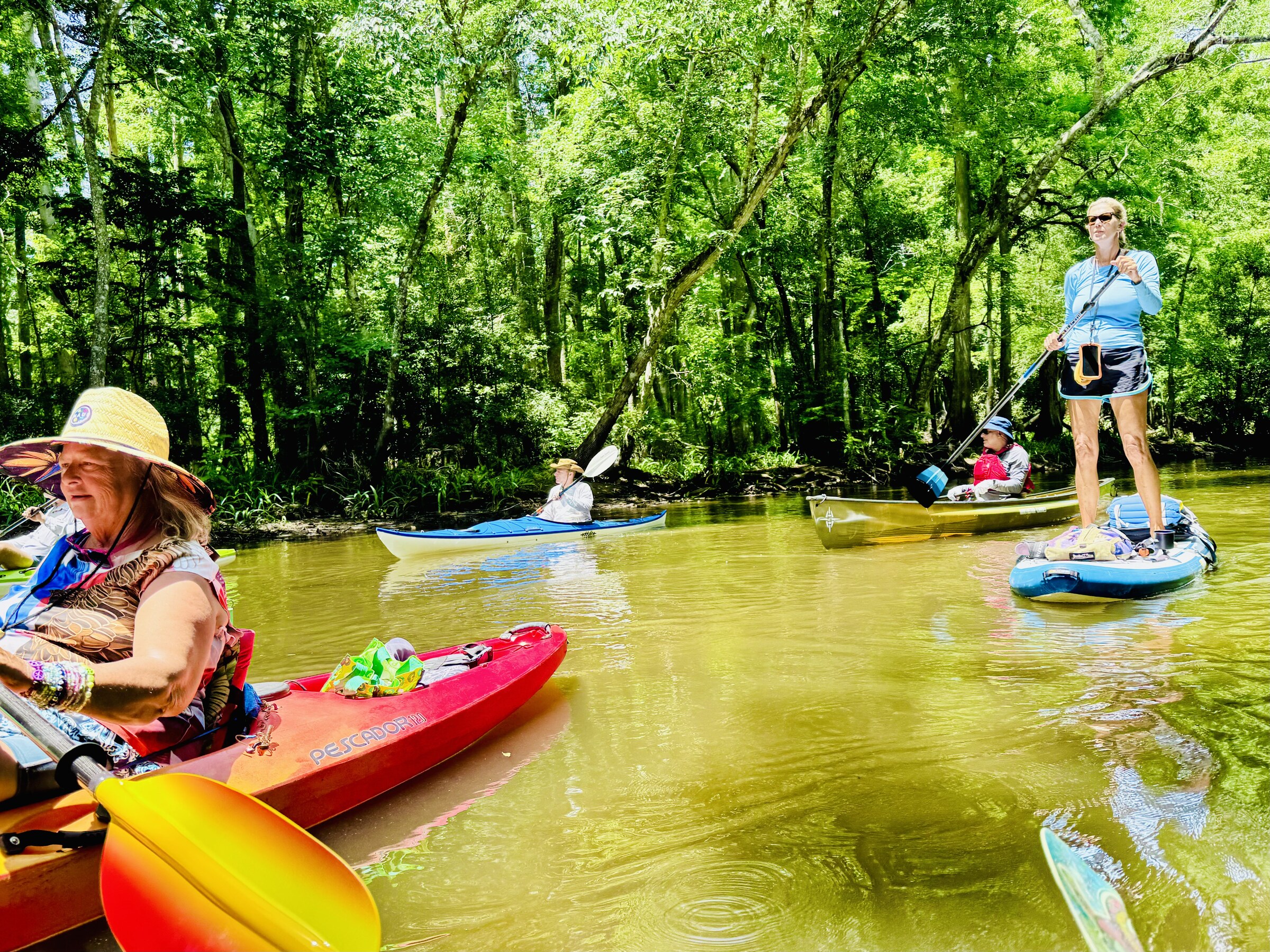 Friends talking from colorful kayaks