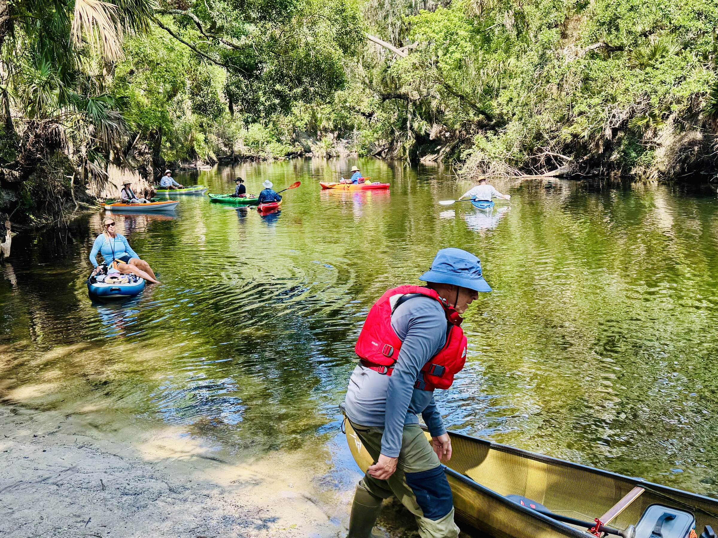 Paddlers launching boats at the edge of the Hillsborough River