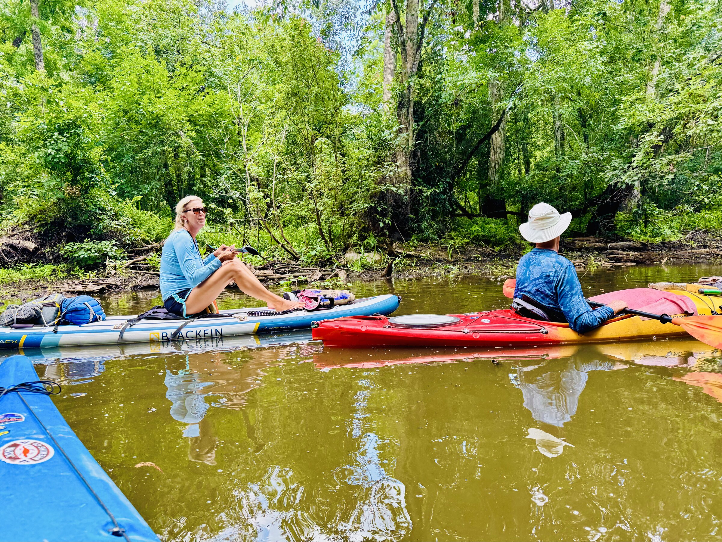 Paddlers resting on calm river water