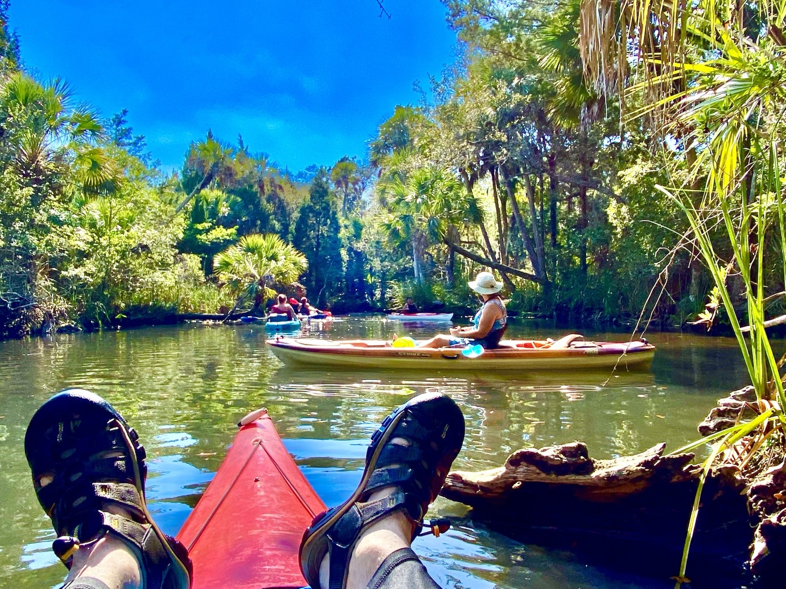 A relaxed paddler's-eye view—feet up, bow pointed toward another quiet stretch of river.