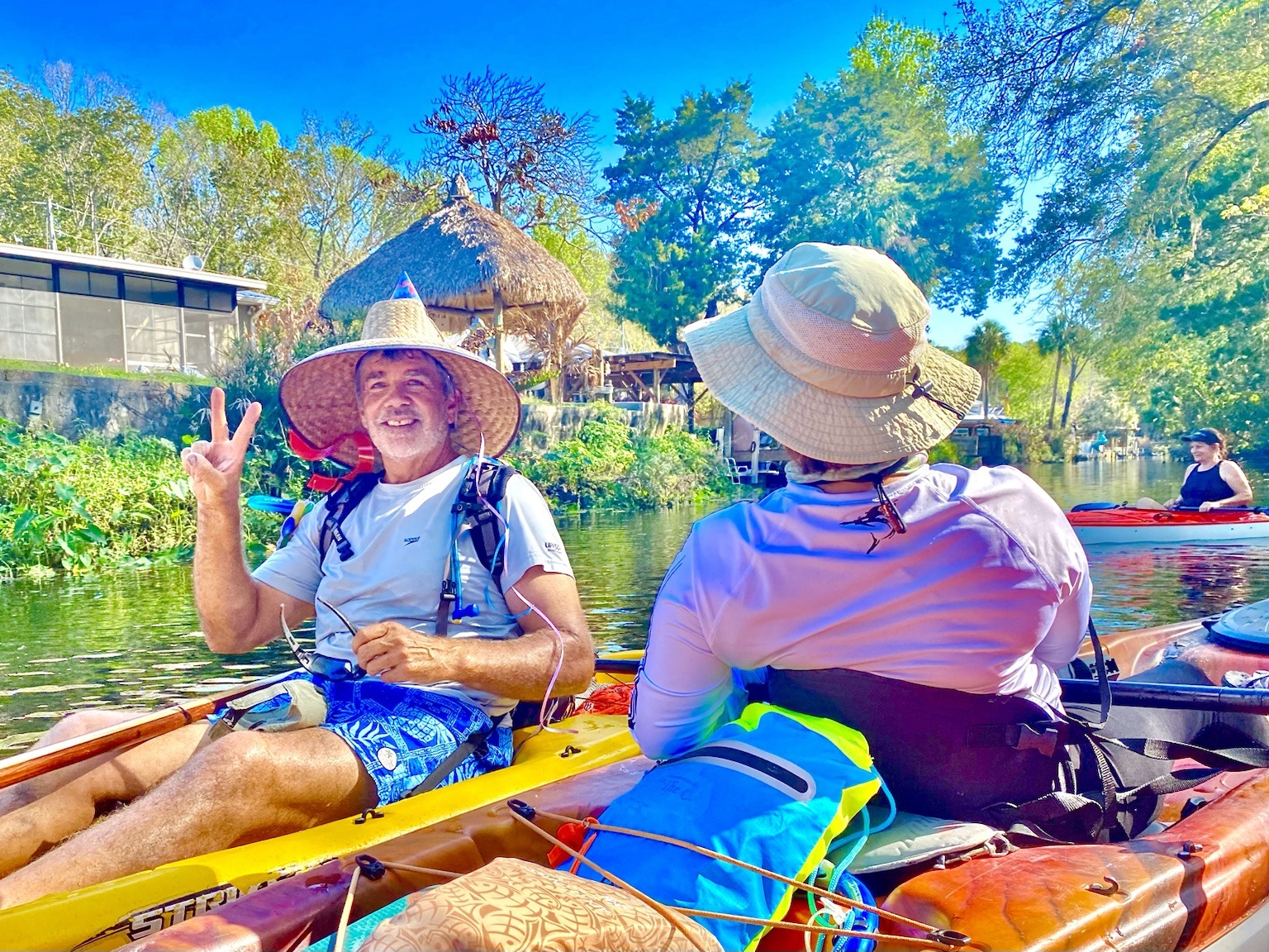 Layne visiting with the group from his kayak, birthday hat towering above the boats.