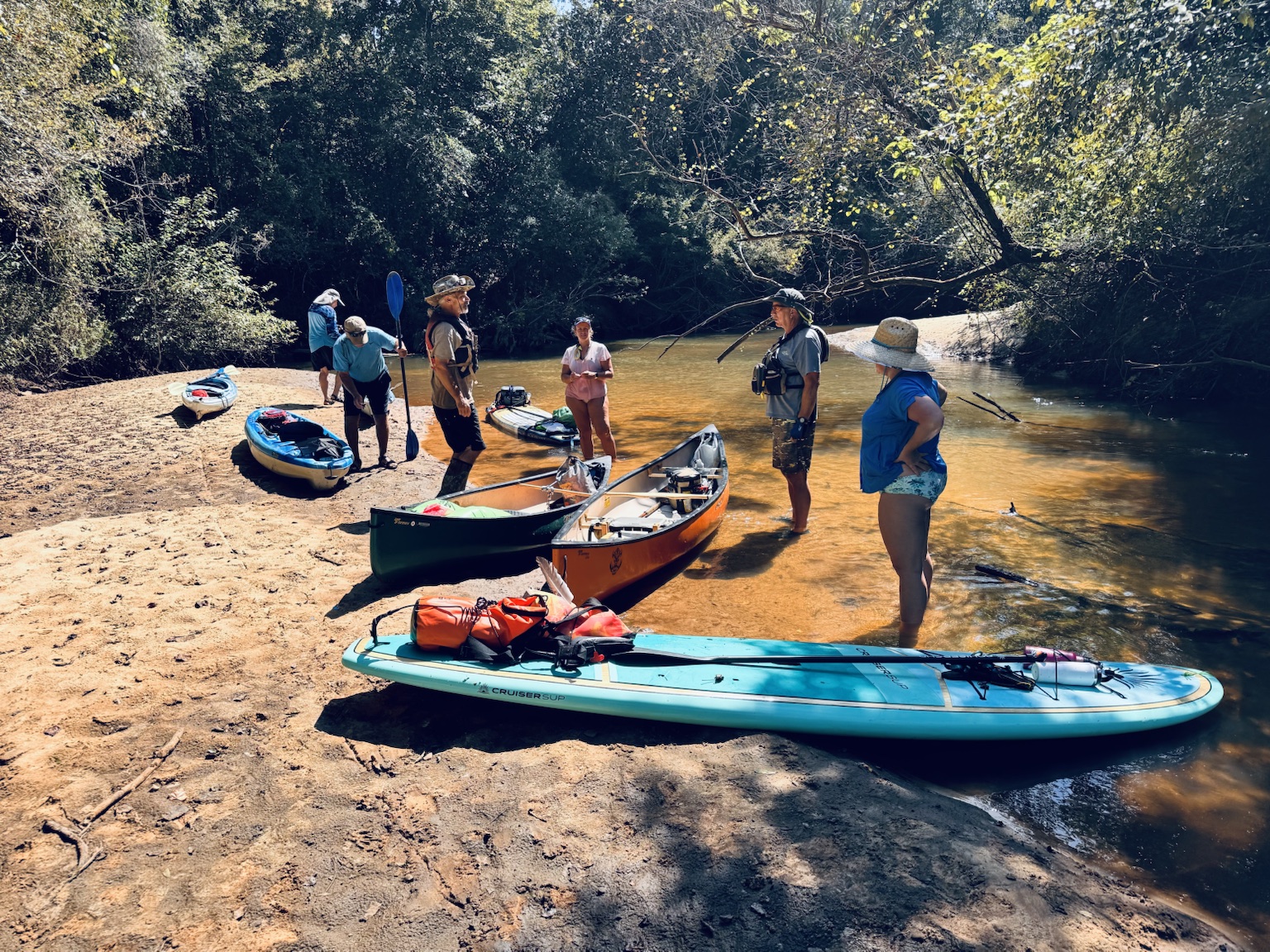 Paddlers resting on a sandbar