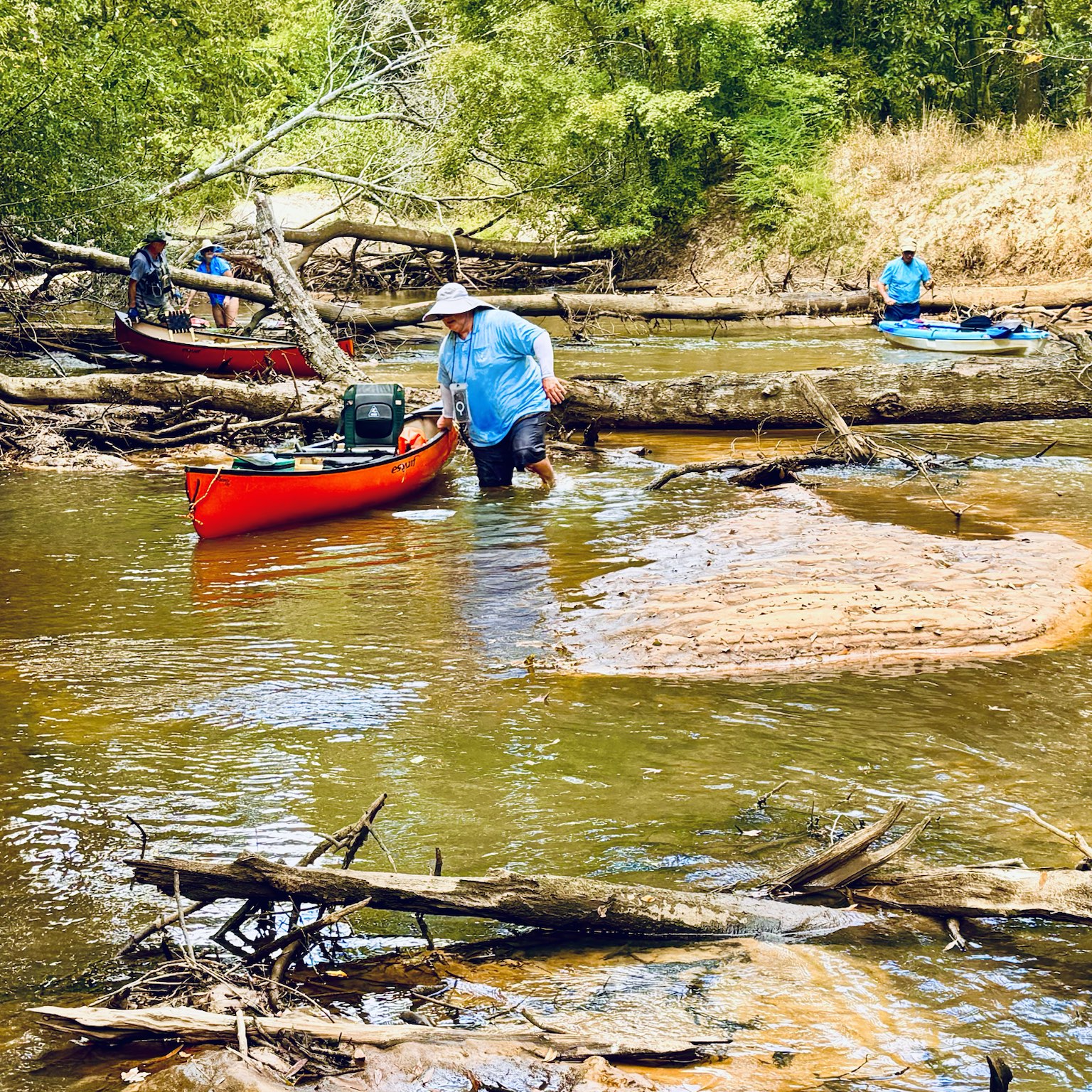 Red kayak at a logjam
