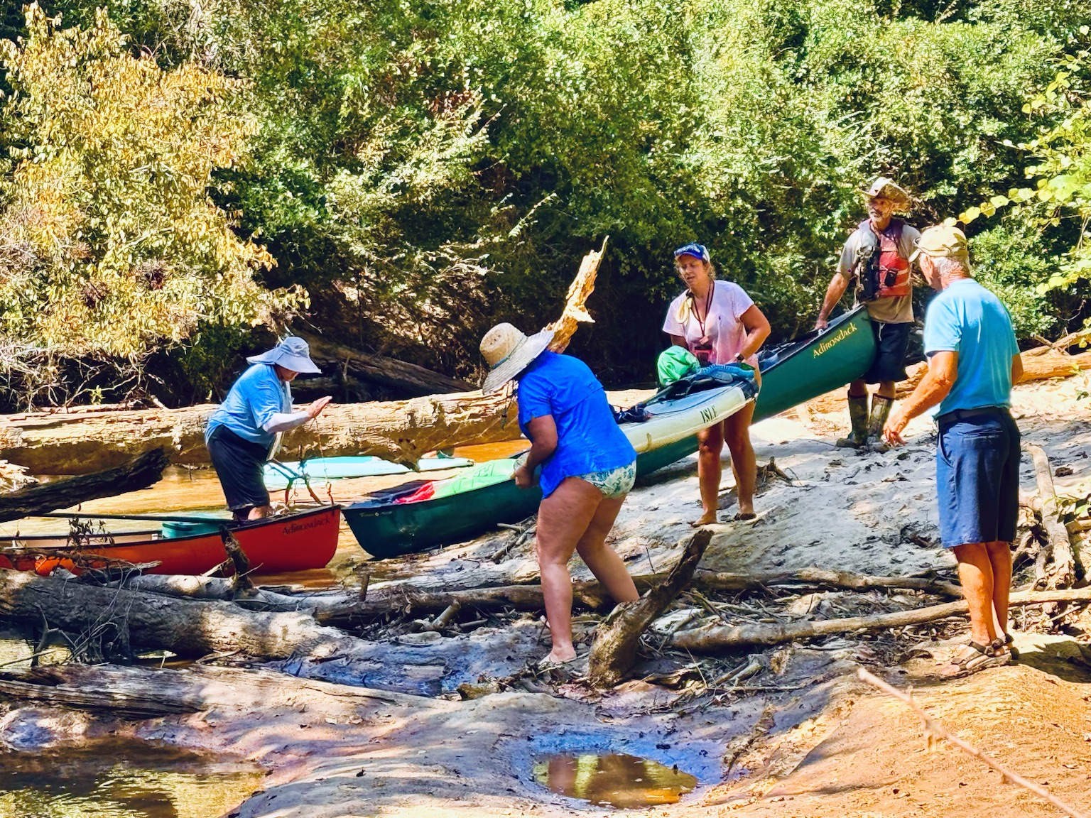 Team carrying boats over a shoal