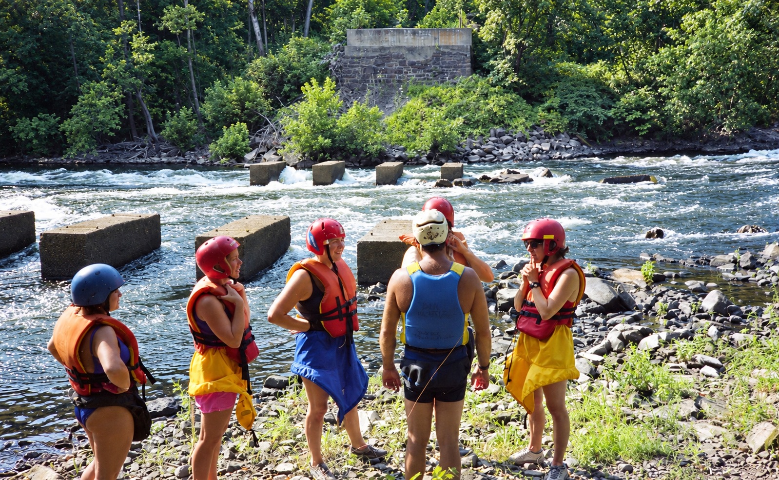 Paddlers gathered beside the rapids.