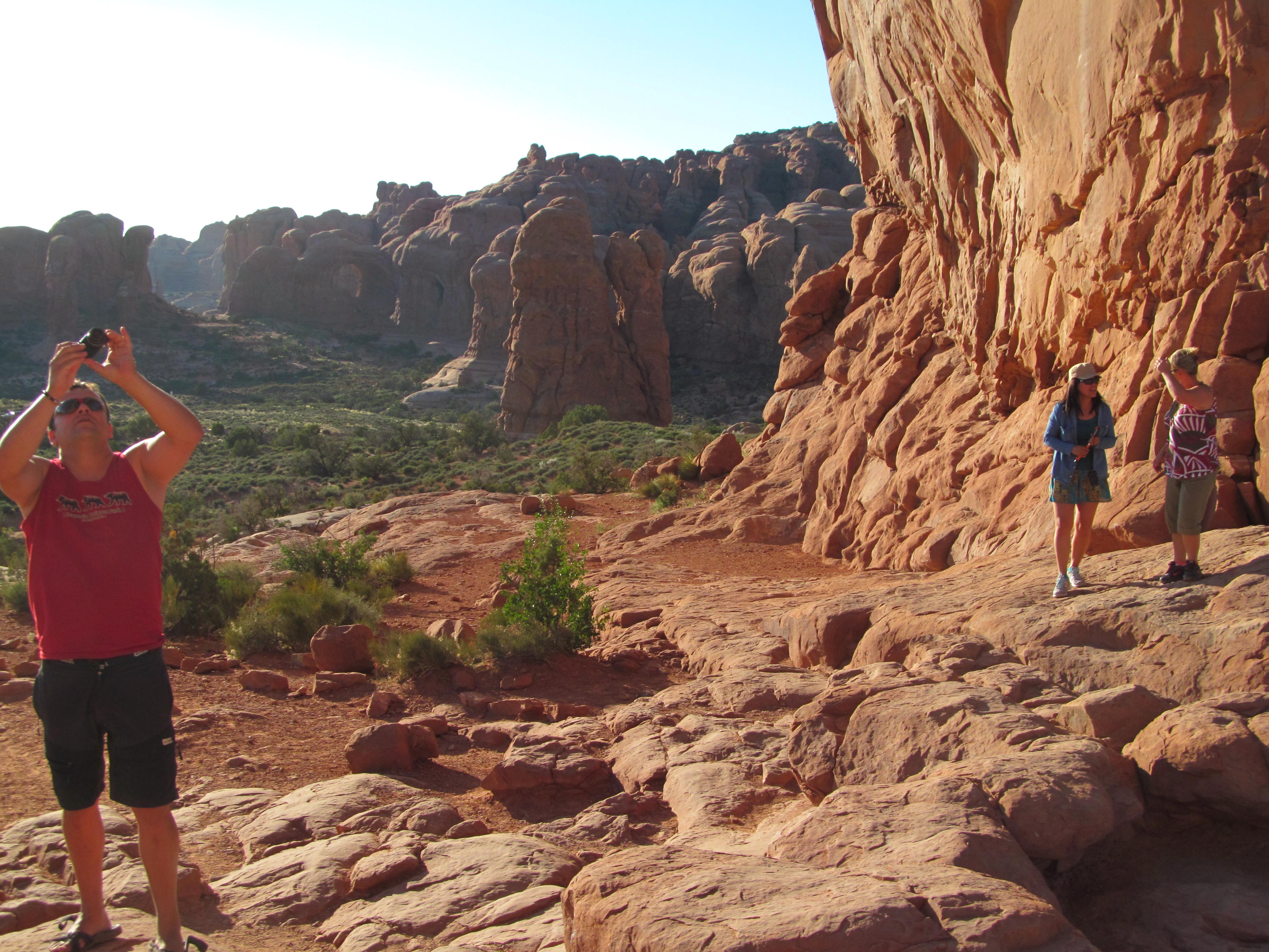 Cindy beside a sculpted sandstone wall on the Windows Trail.