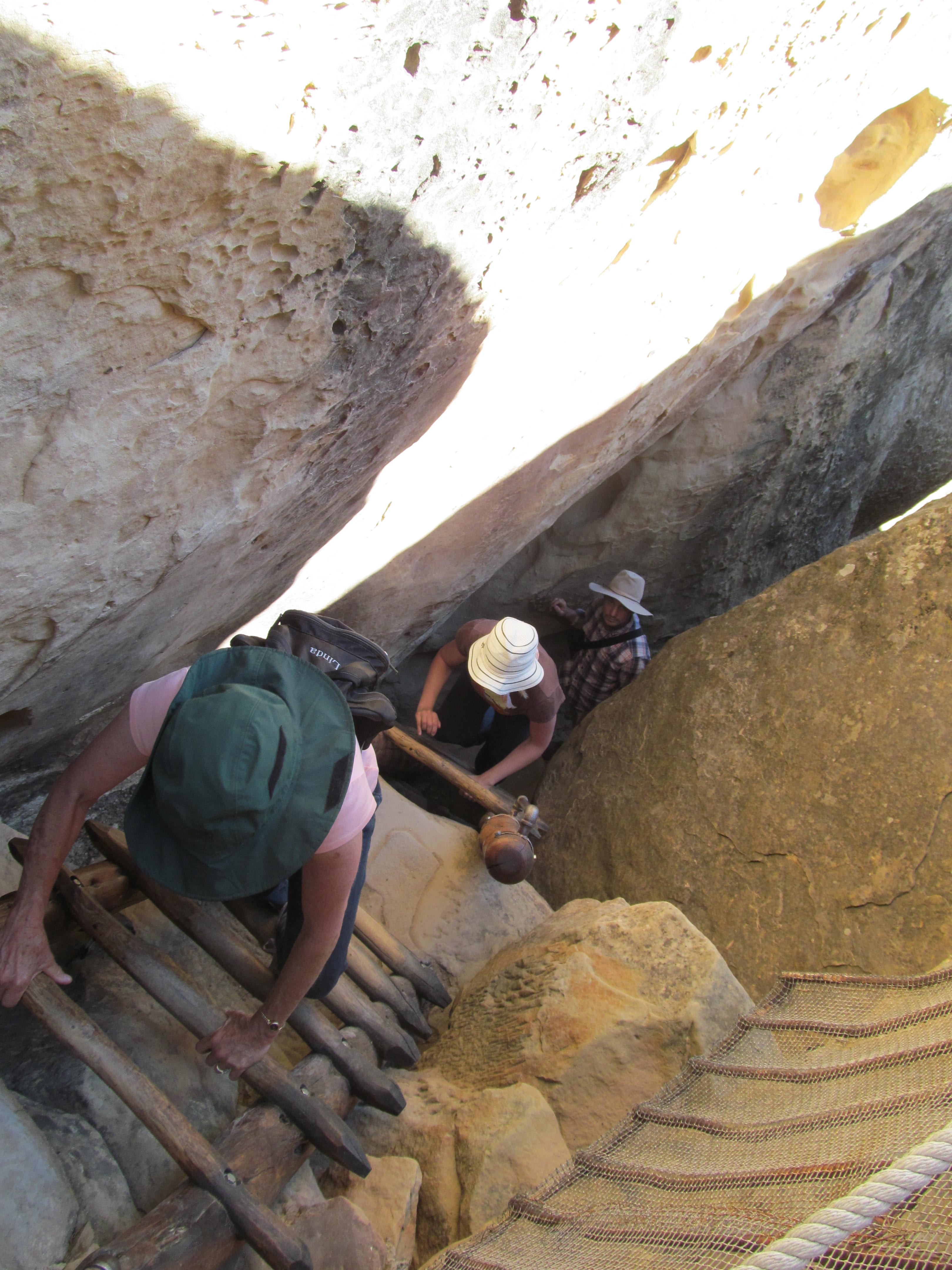 Cindy climbing steep stone steps on the route back to the mesa top.