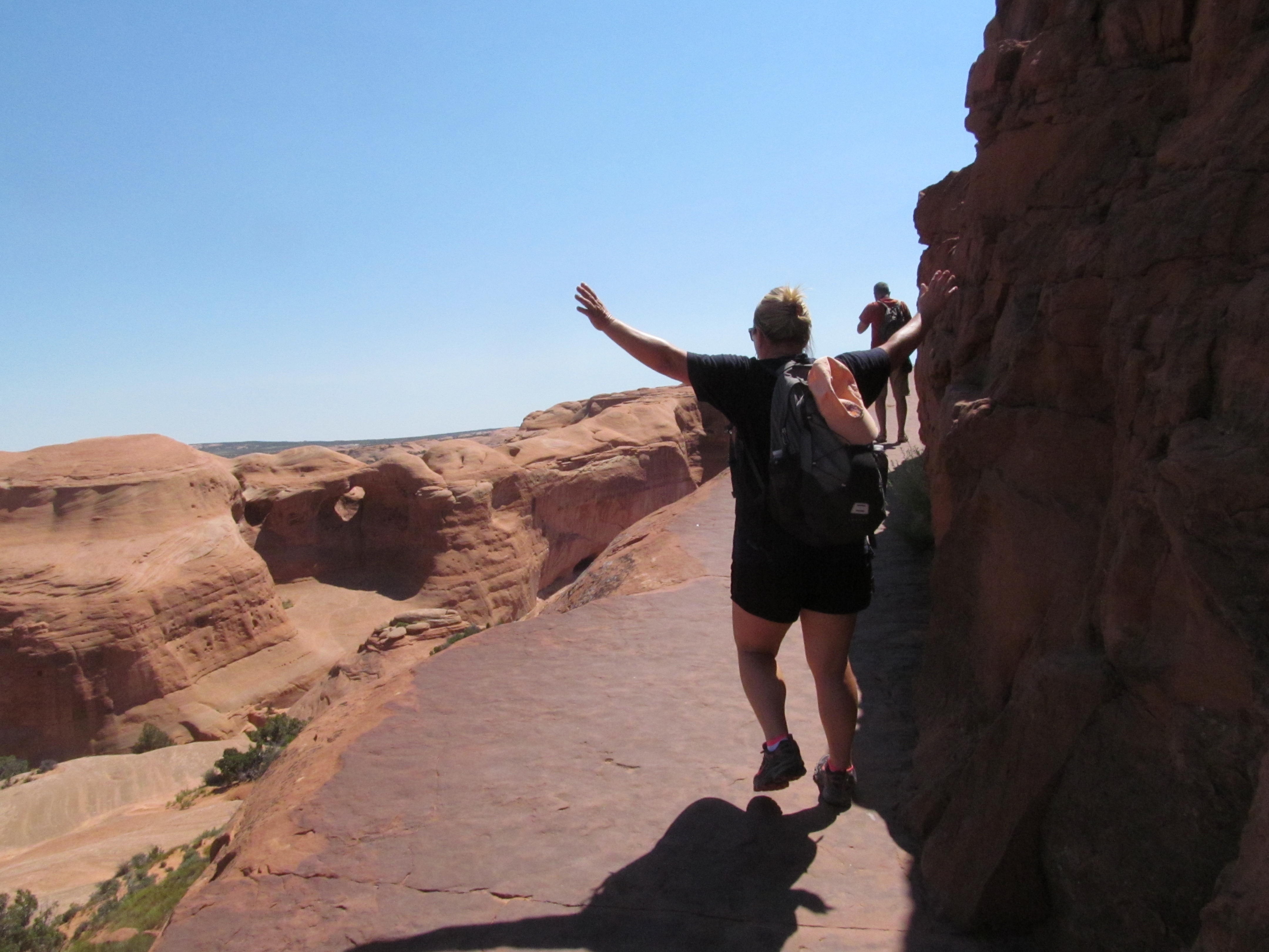 Cindy hiking the exposed slickrock approach to Delicate Arch.