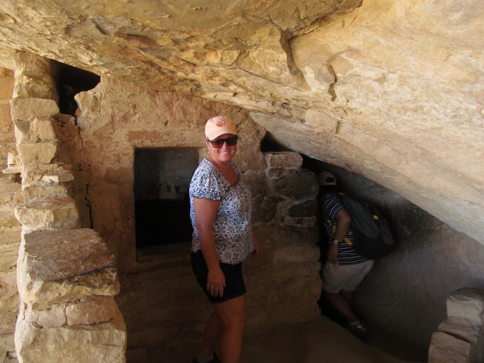 Cindy inside one of the sheltered rooms built beneath the sandstone overhang.