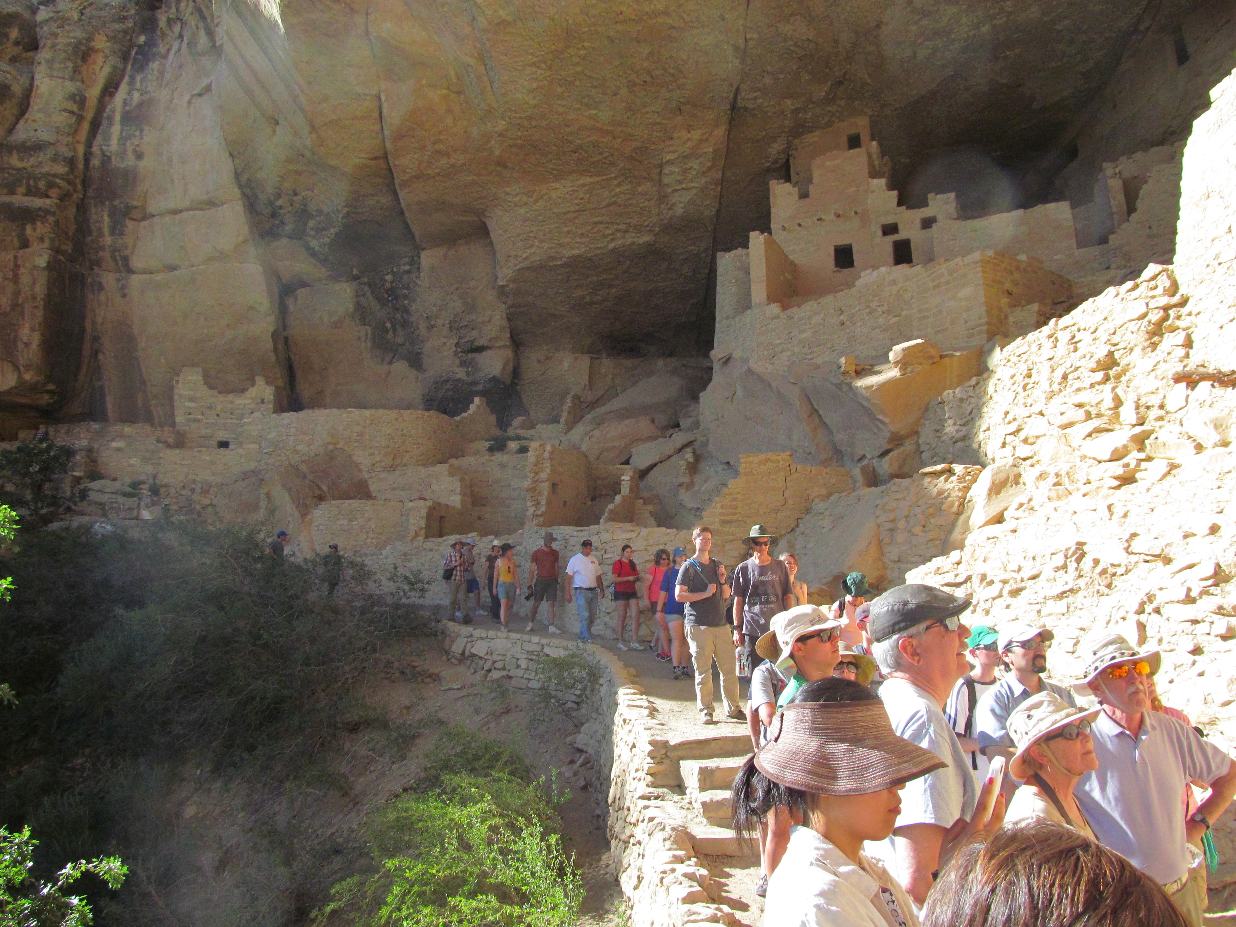 Our tour group moving through the protected alcove at Cliff Palace.