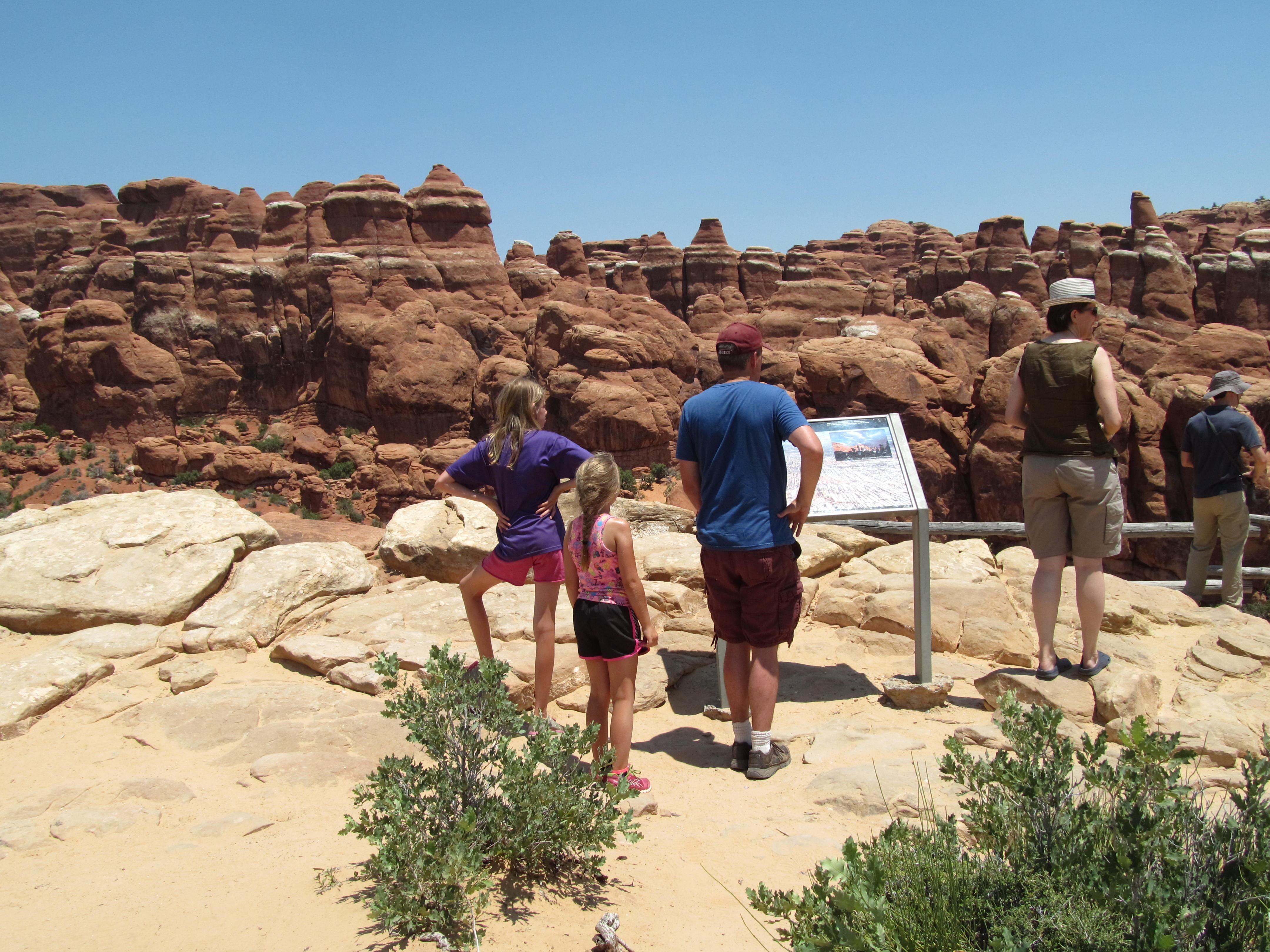Hikers entering the rugged rock fins of Devils Garden.