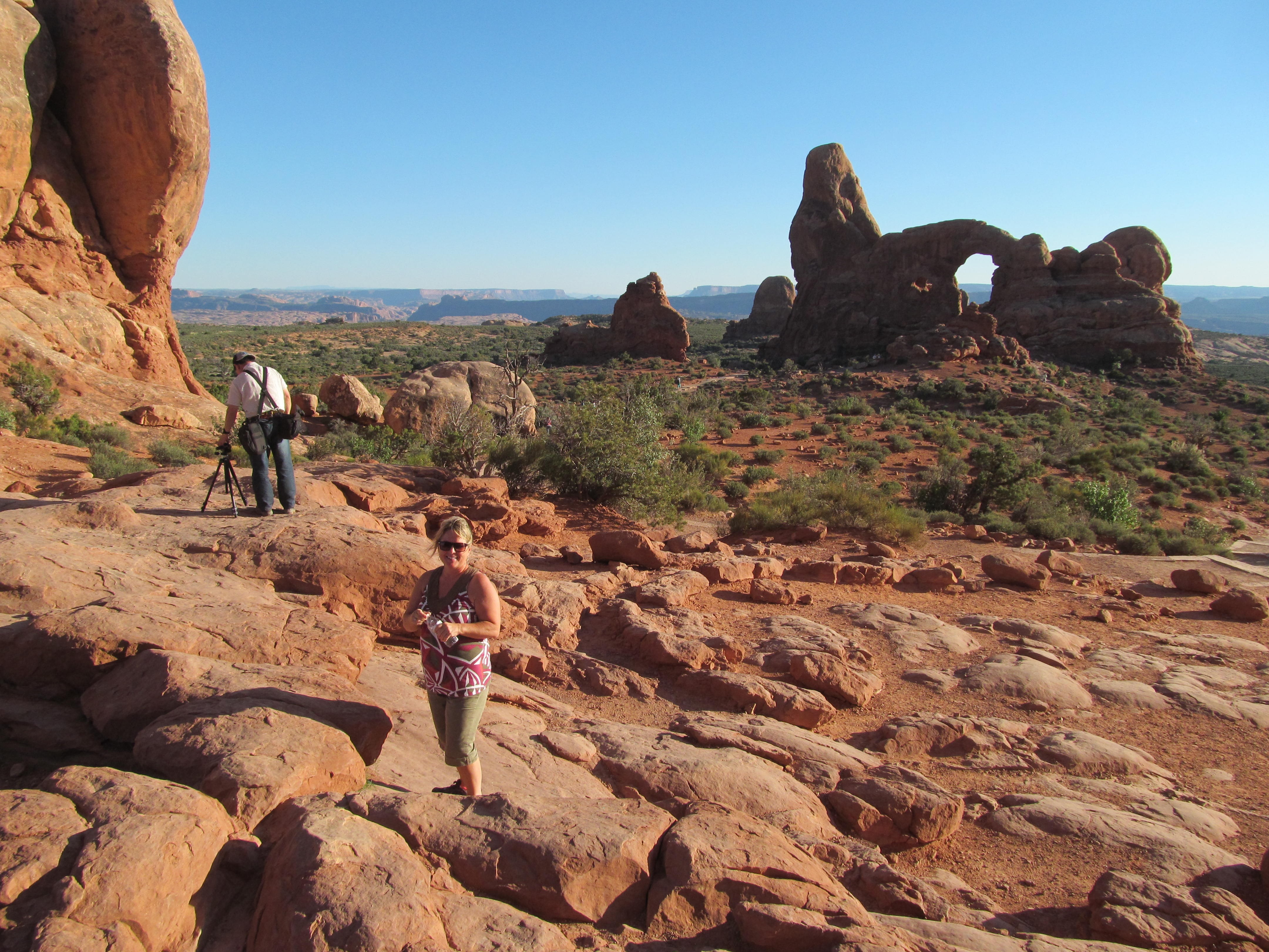 Hikers moving among the rounded formations near the Windows.
