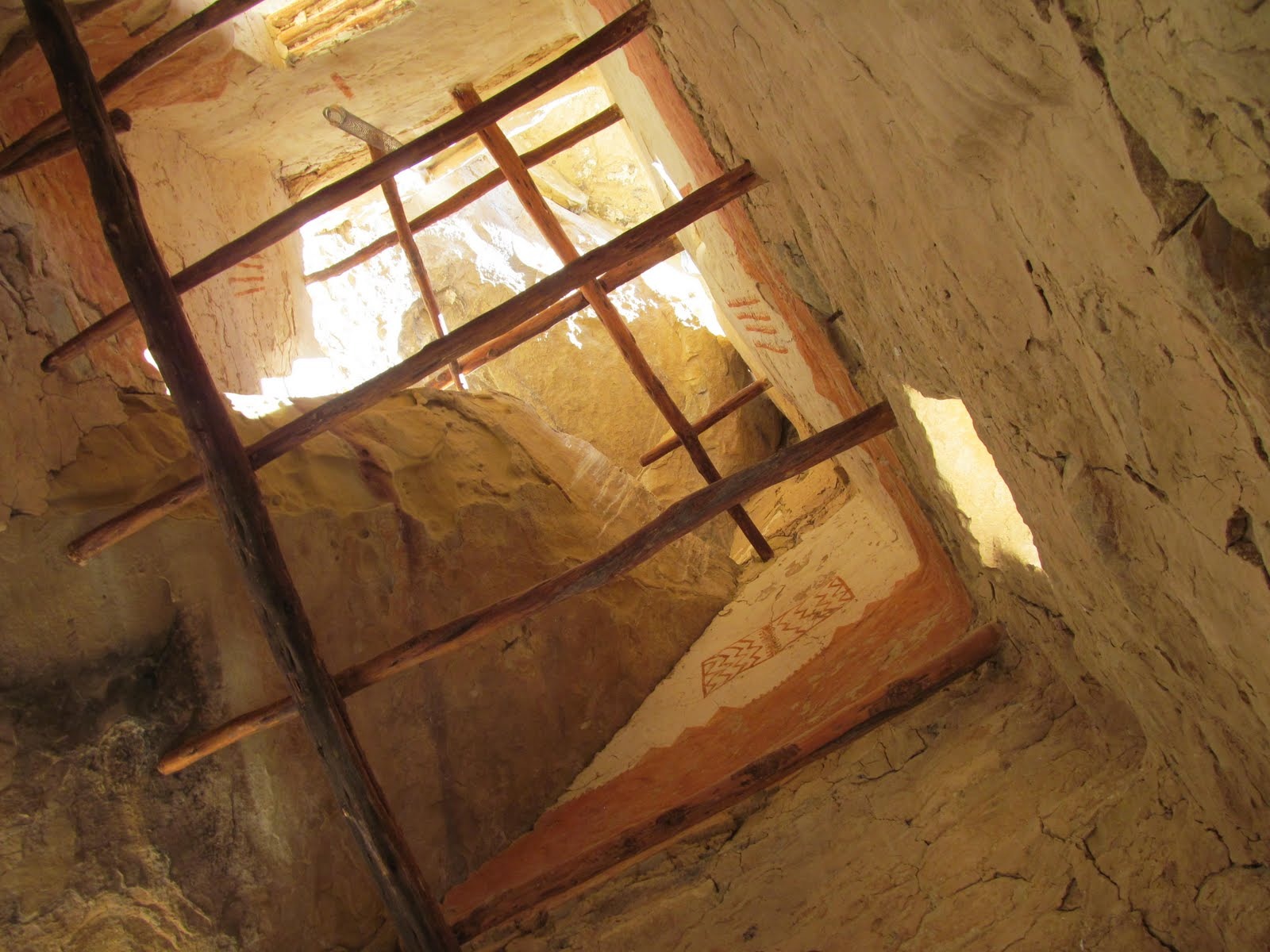Looking upward through a ladder opening inside the cliff dwelling.