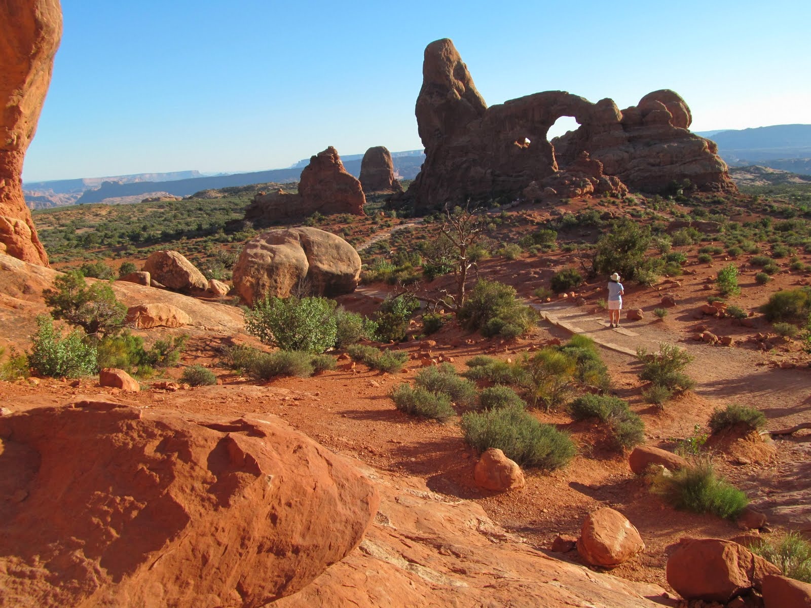 Red rock formations rising above the open desert basin.