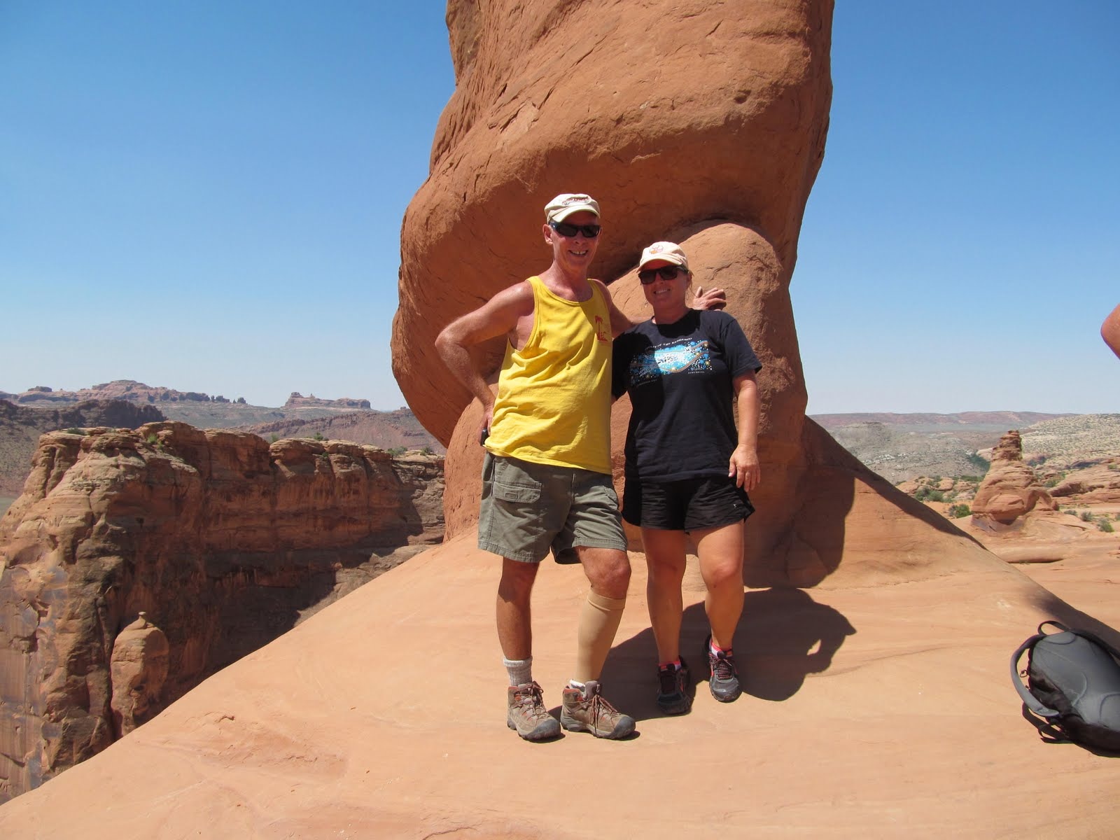 Tim and Cindy standing together beneath Delicate Arch.