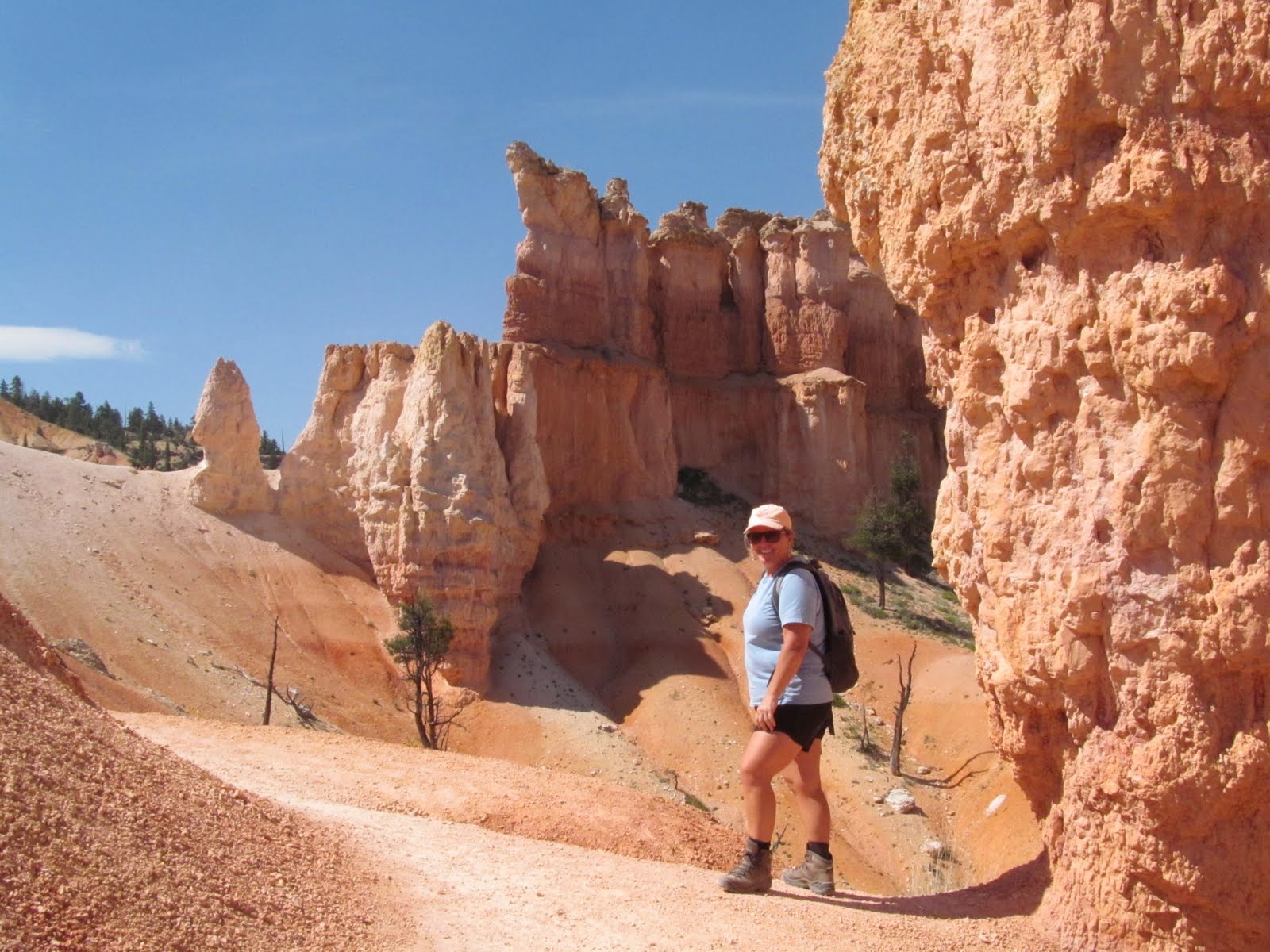 Tim hiking through a narrow corridor between Bryce Canyon hoodoos.