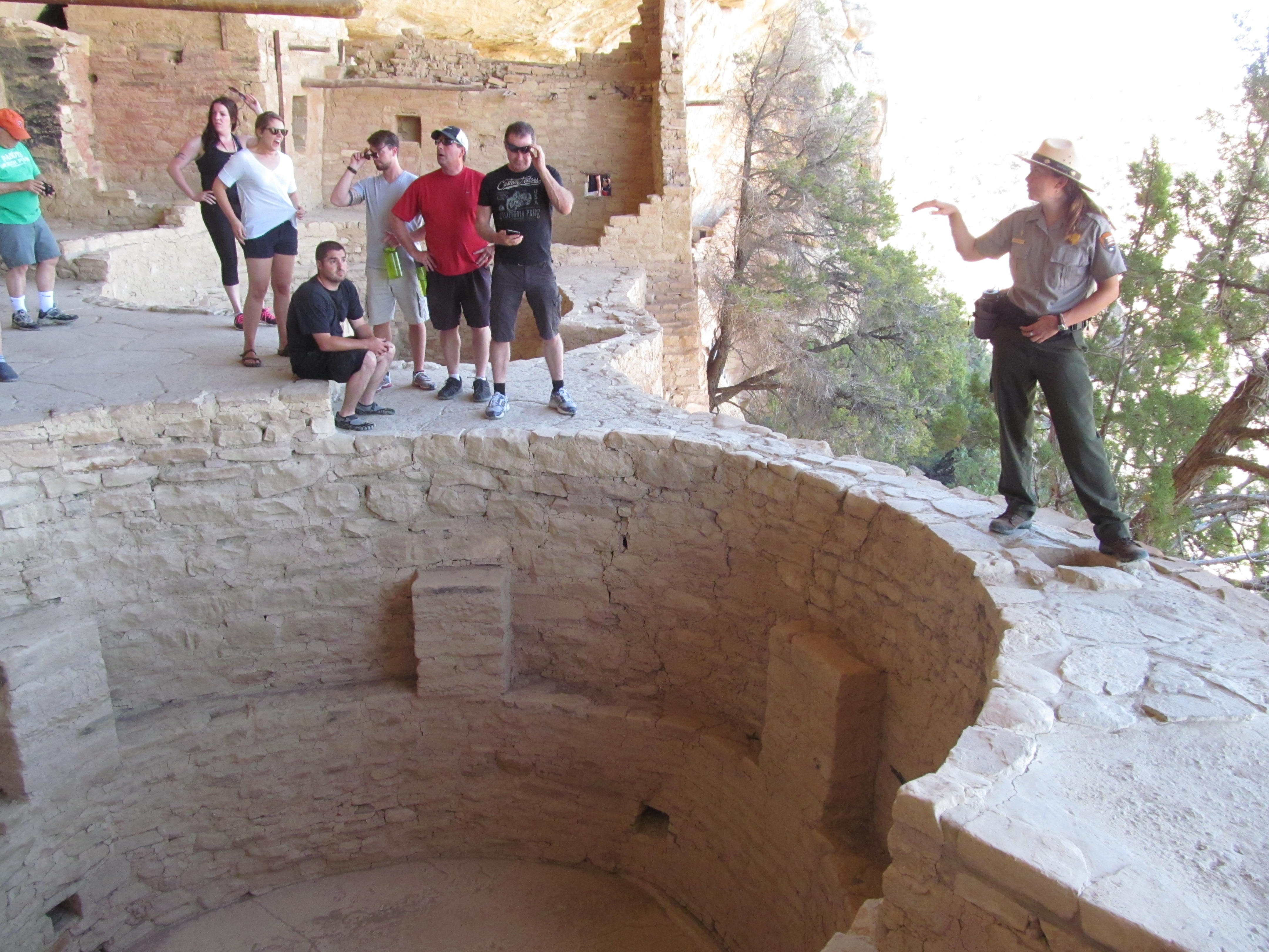Visitors gathered around a kiva while learning about life in the cliff dwelling.