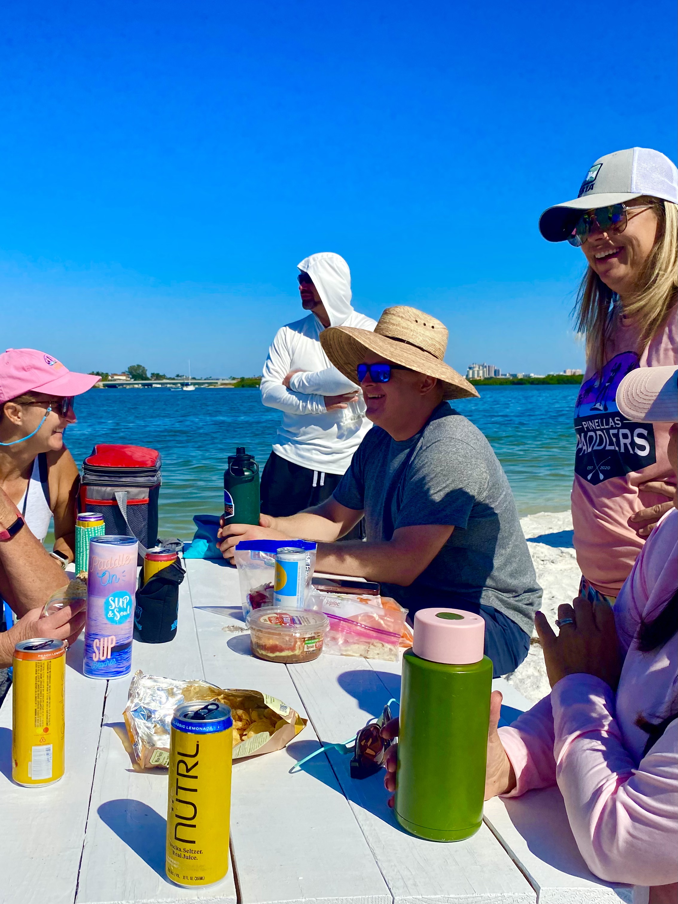 Friends gather around the picnic table for lunch and conversation on the island.