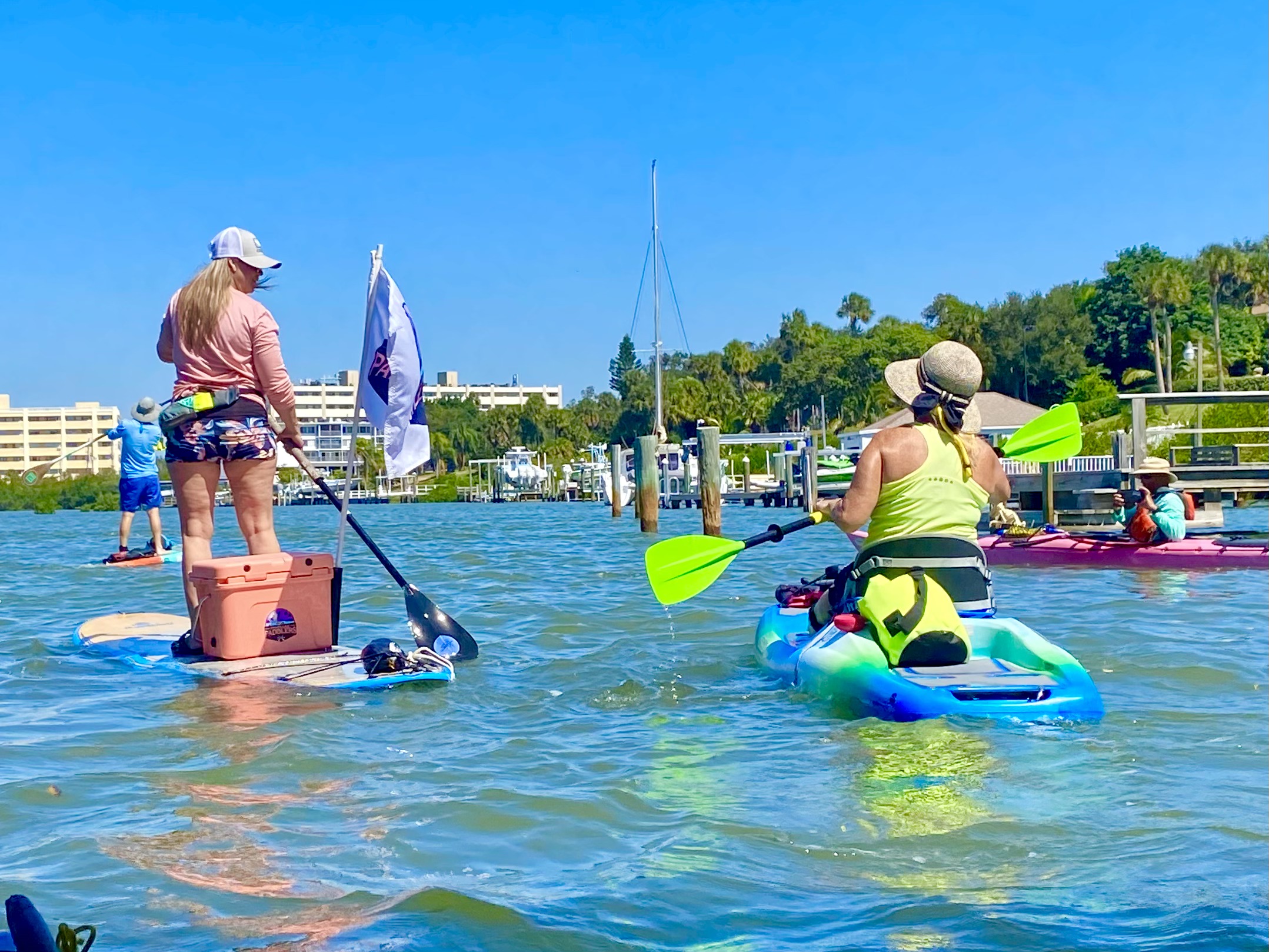 Kayaks and paddleboards travel together on the easy return trip.