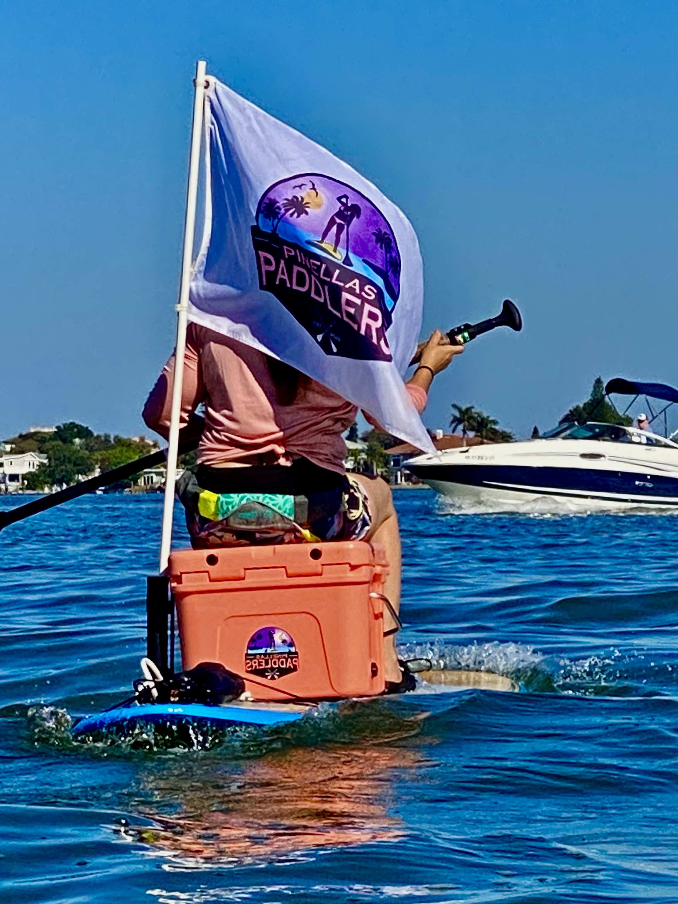 The Pinellas Paddlers flag flies from a board during another relaxed group outing.