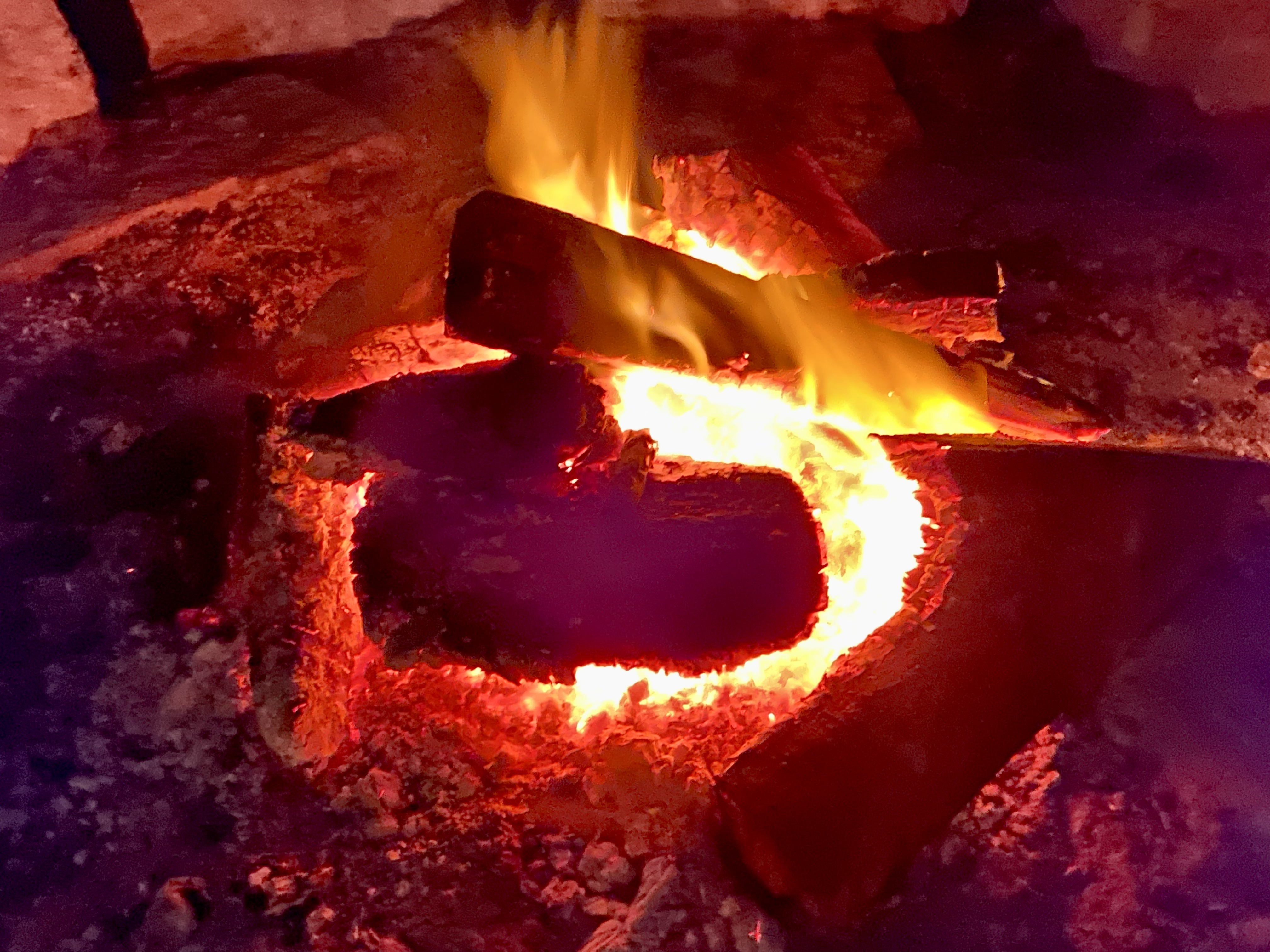The ceremonial fire, a steady source of warmth and focus through the night.