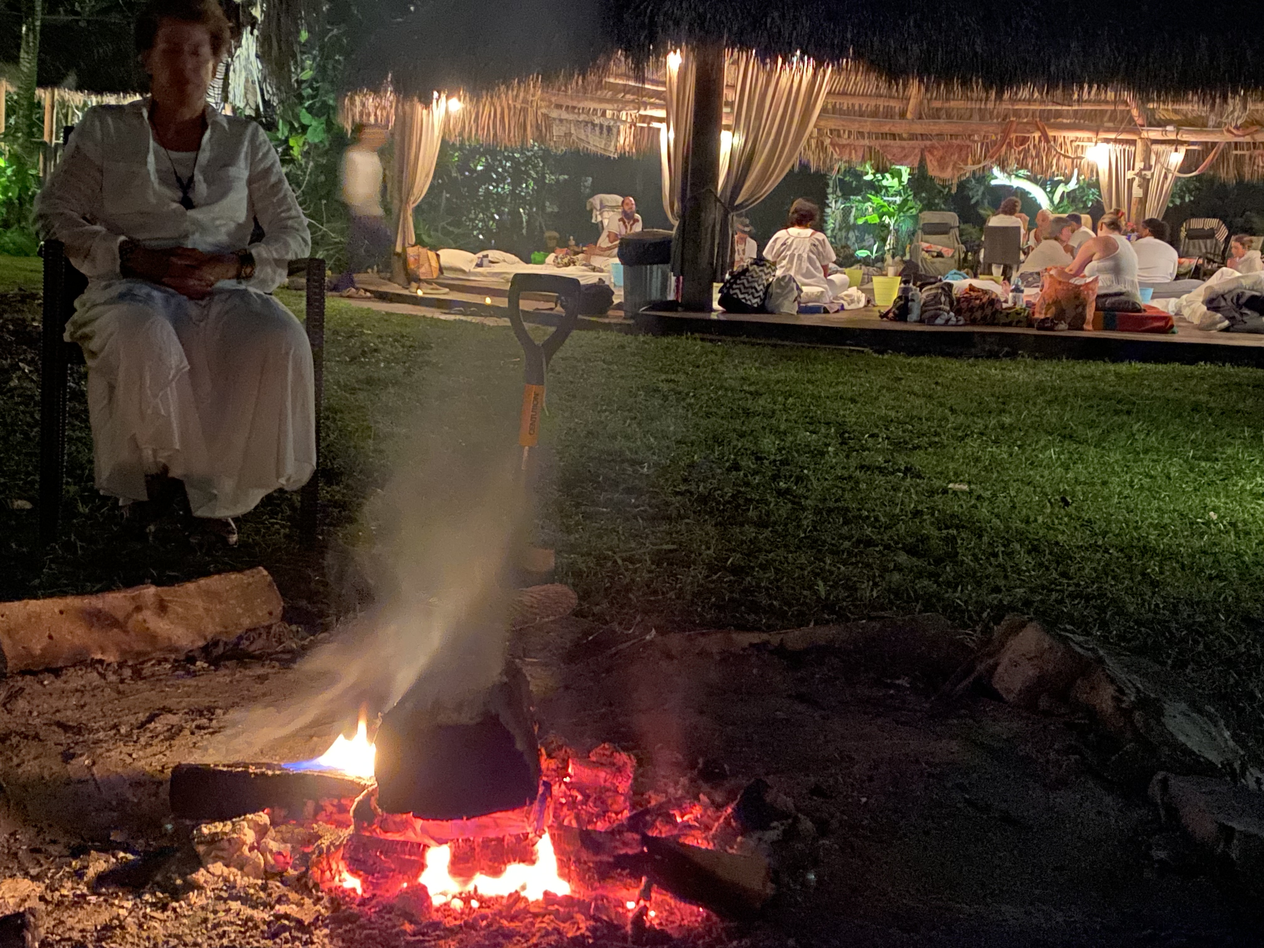 The fire being carefully tended during the nighttime ceremony.