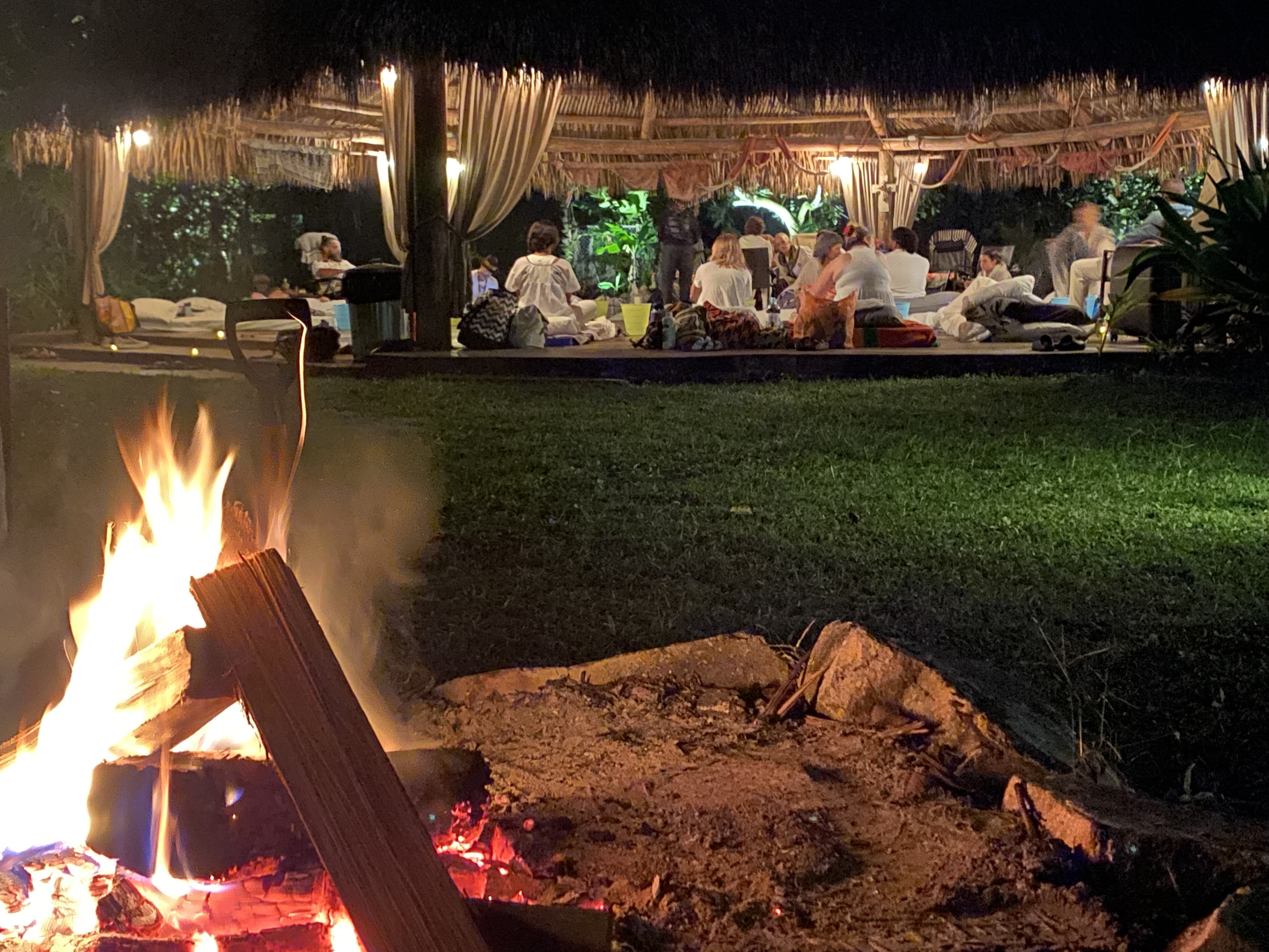 The ceremonial fire burning beside the open pavilion.