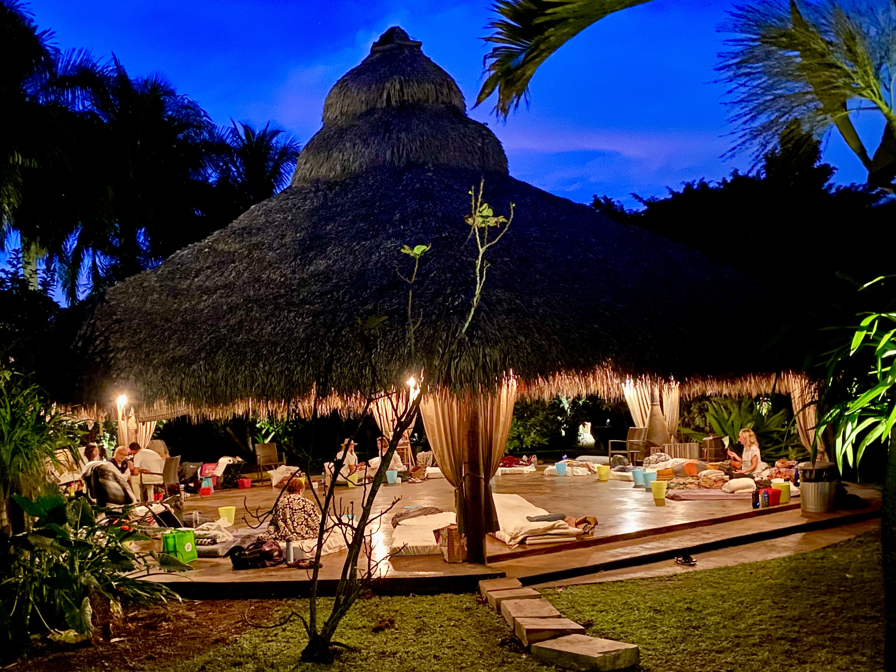 Blue hour settling over the thatched pavilion and tropical Redlands landscape.