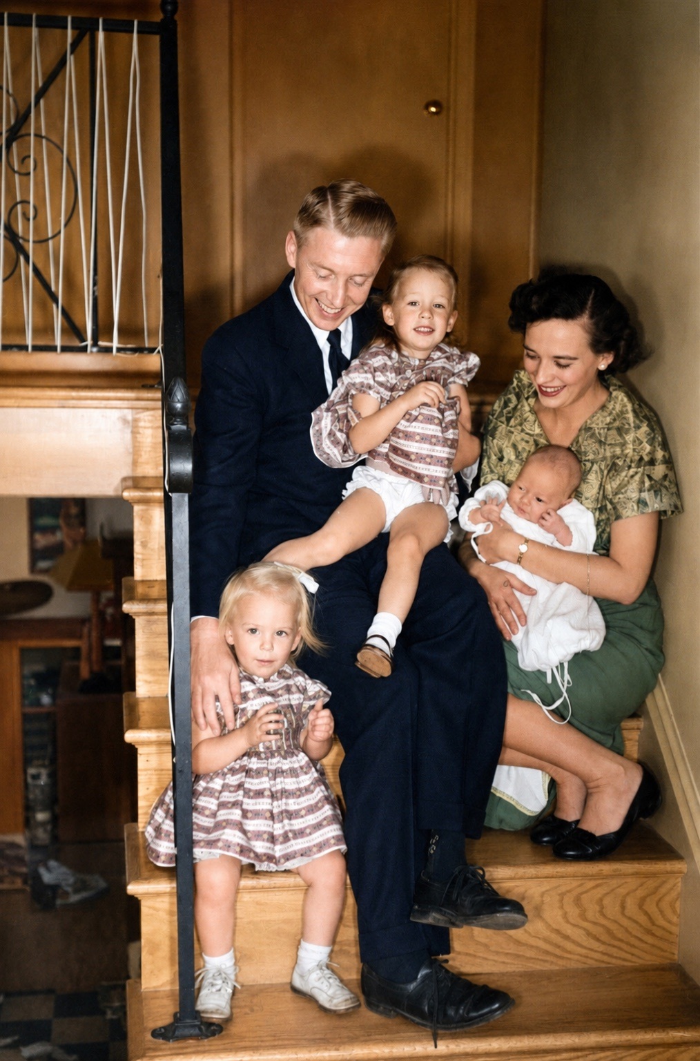 Dad holding Peg, Sharlotte on the steps, and Mom holding baby Tim