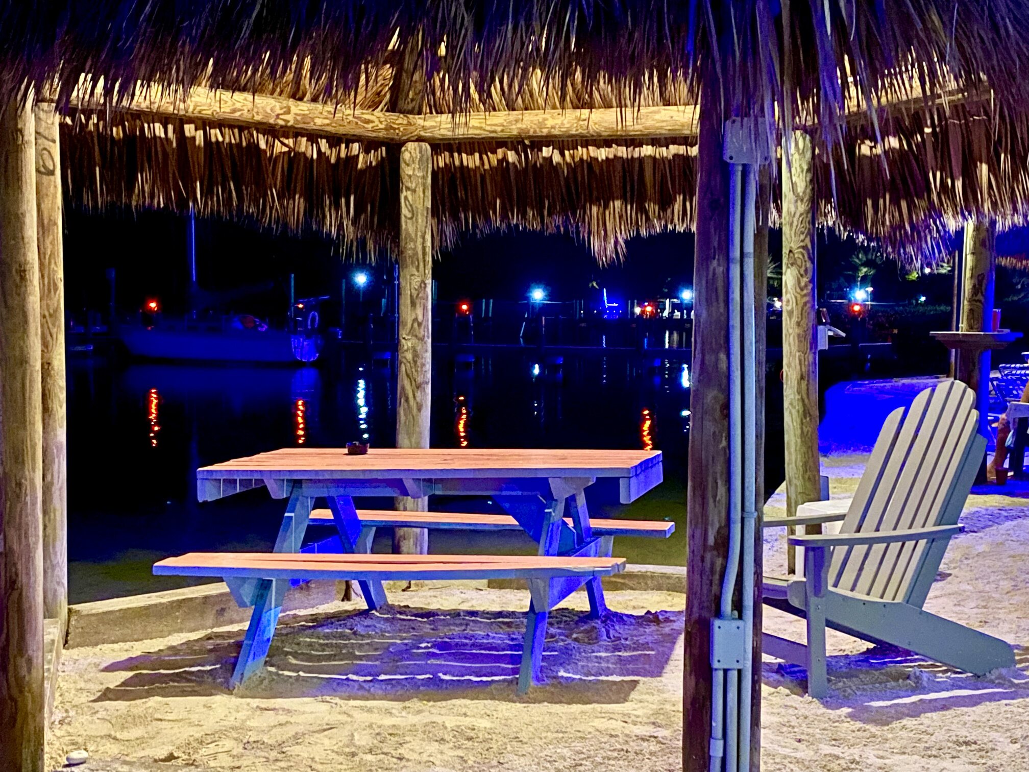 The waterfront tiki hut glowing after dark.