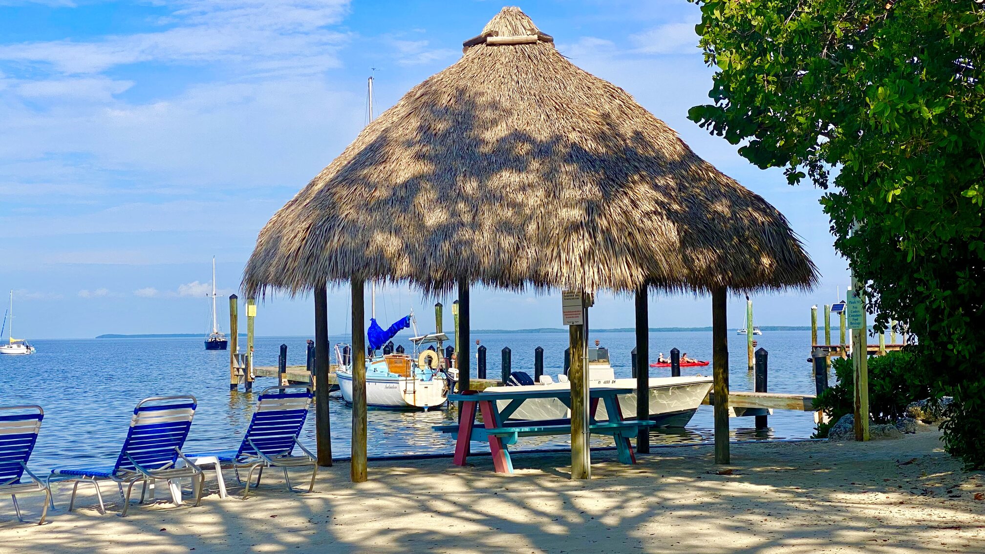 The sandy waterfront at Sunset Cove Beach Resort.