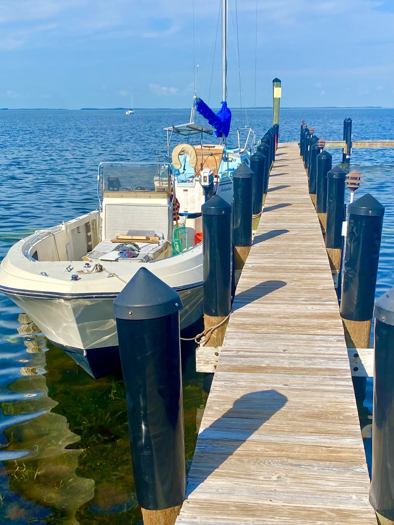 A small boat tied beside the dock on Florida Bay.