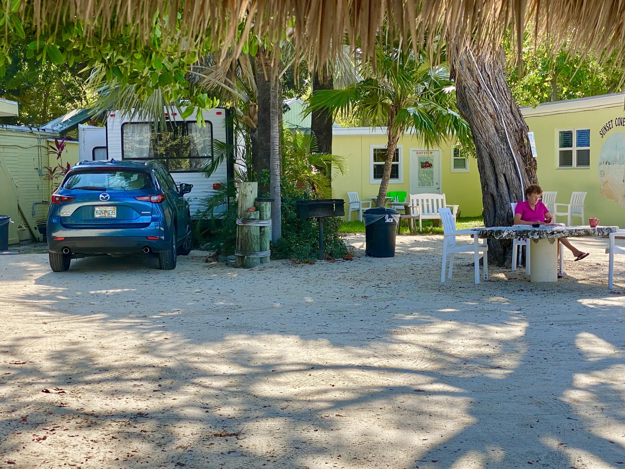 Simple cottages tucked among palms and sandy paths.